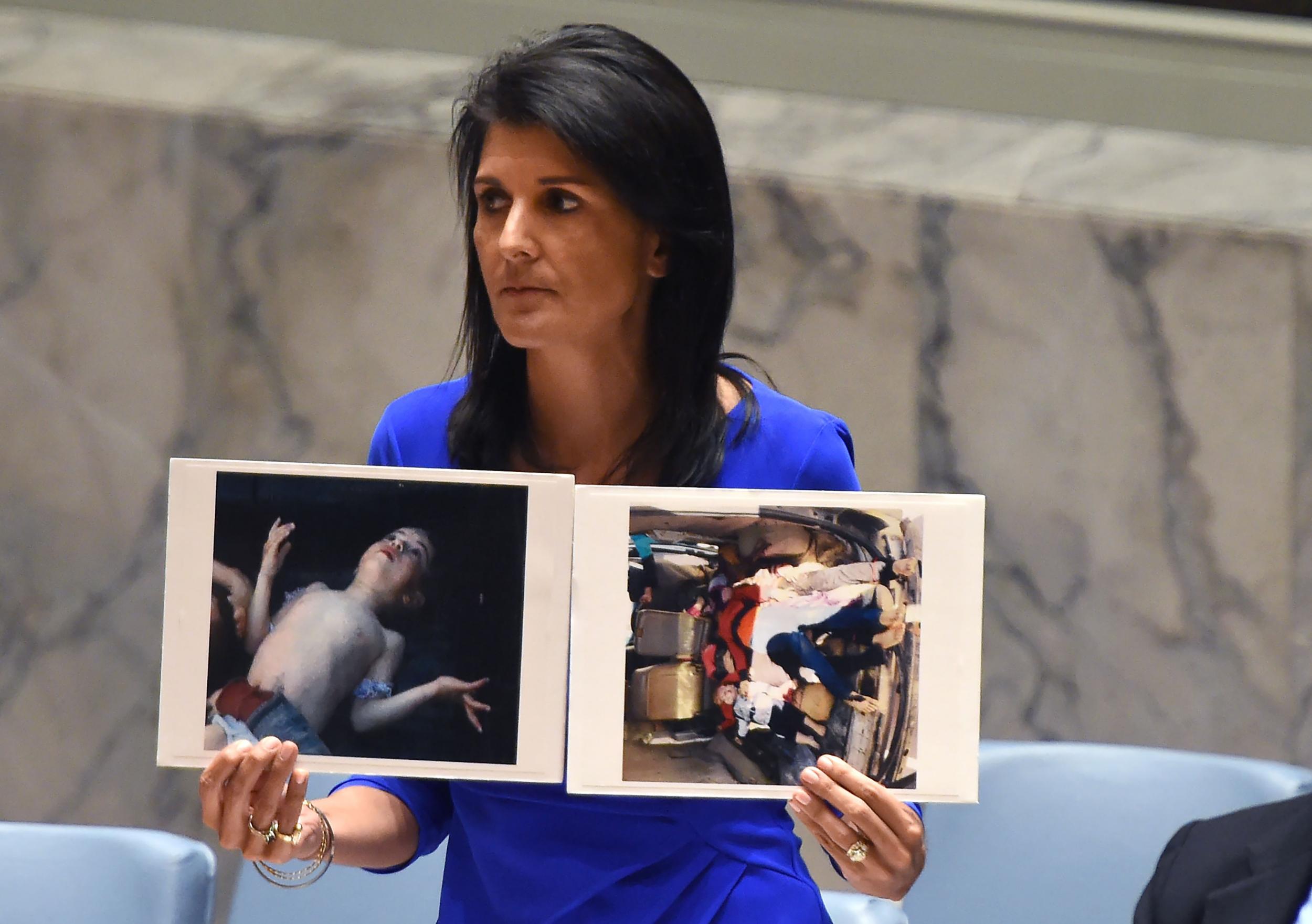 Nikki Haley, US ambassador to the UN, with photos of victims killed in chemical weapons attacks as she speaks during an emergency session at the UN about Syria in 2017