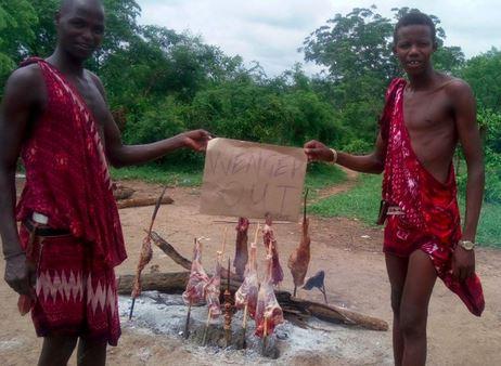 The now ubiquitous 'Wenger Out' sign is held aloft by two men in the Kalahari desert. Supposedly...