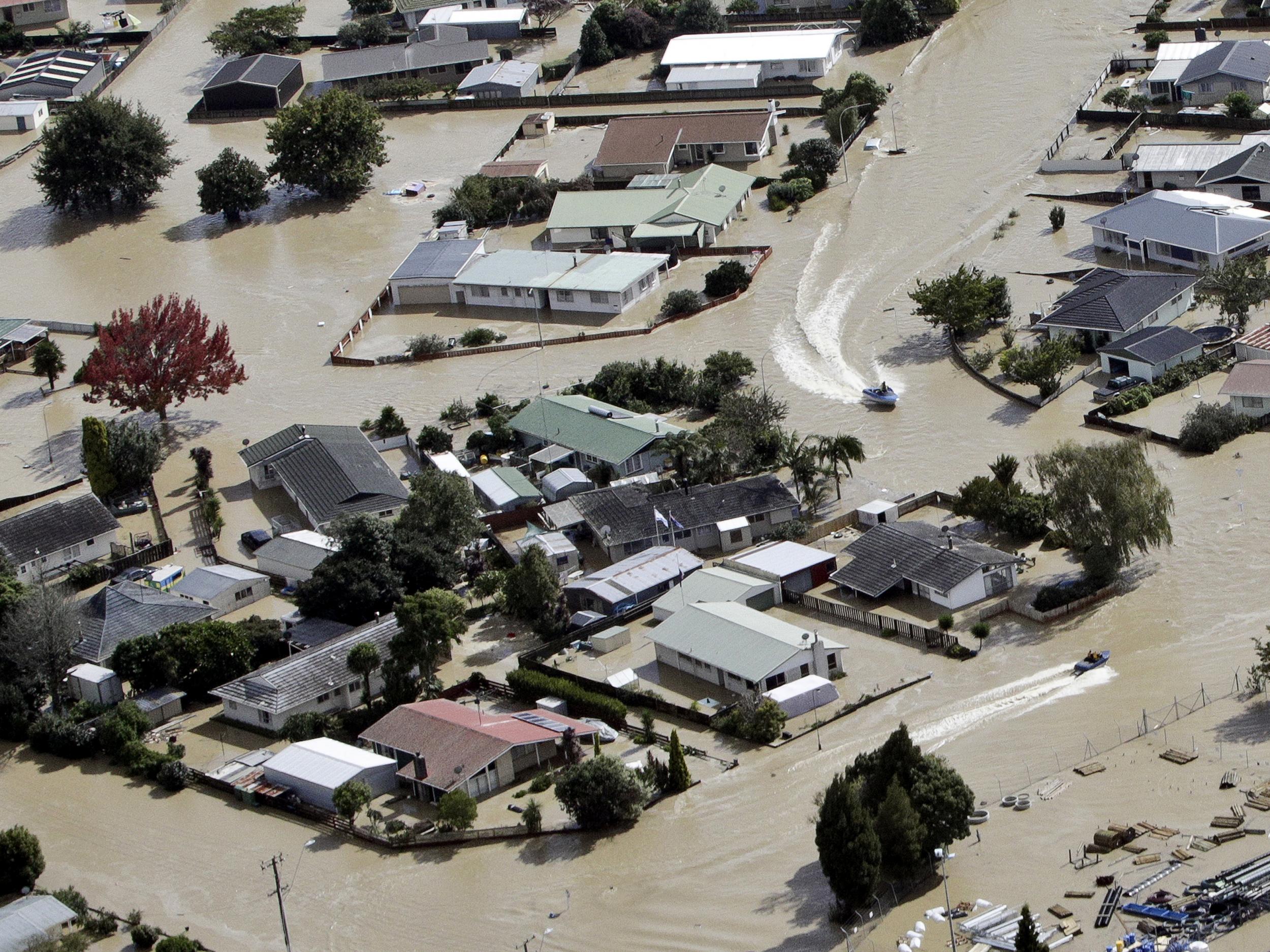 Jet boats drive through the flooded streets of the North Island town of Edgecumbe in New Zealand