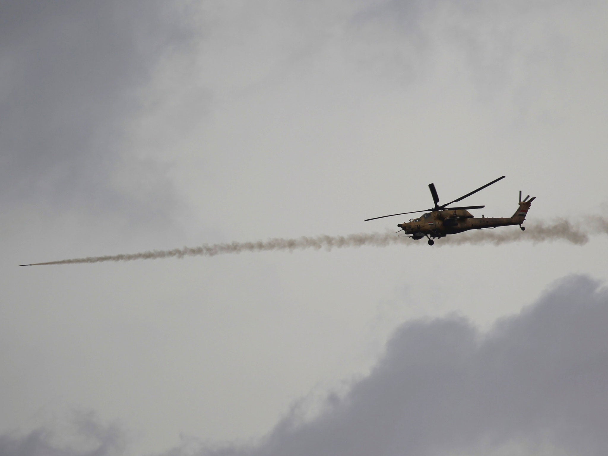 An Iraqi helicopter fires a missile against Isis militants during a battle in Mosul, Iraq, on 28 March