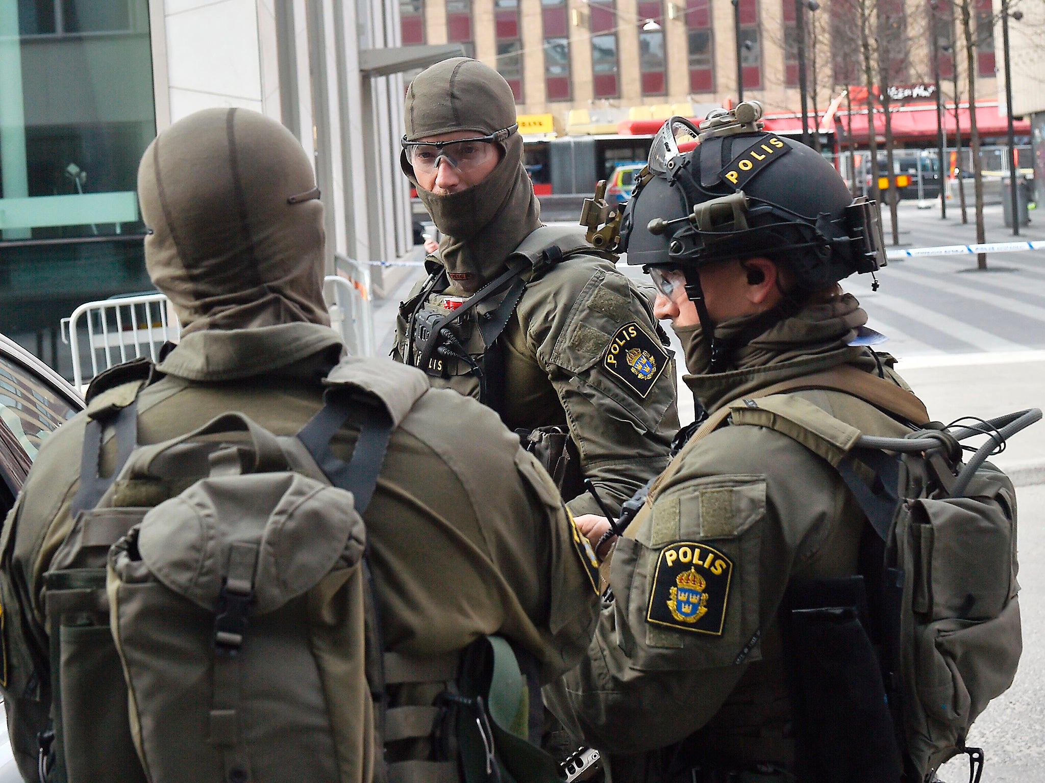 Police at the scene where a lorry crashed into the Ahlens department store in central Stockholm