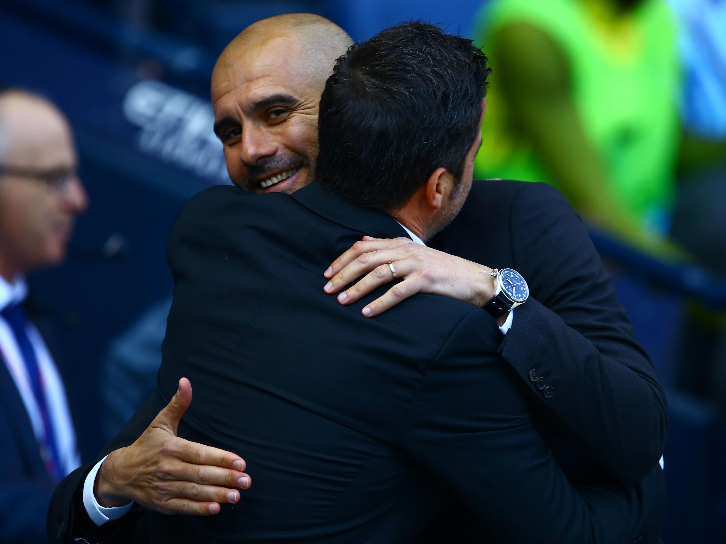 The two managers embrace ahead of kick-off