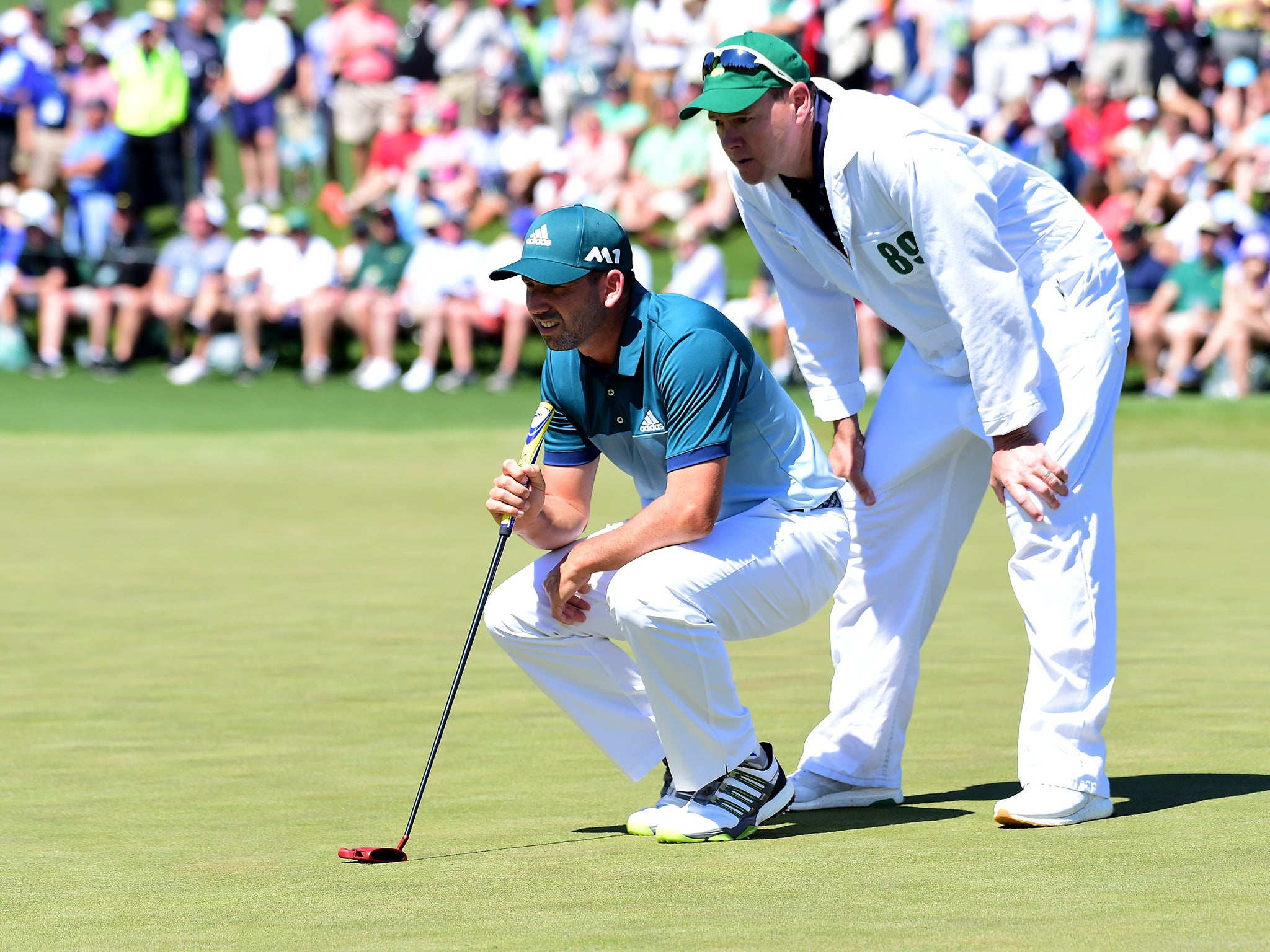 Garcia lines up a putt with caddie Glen Murray