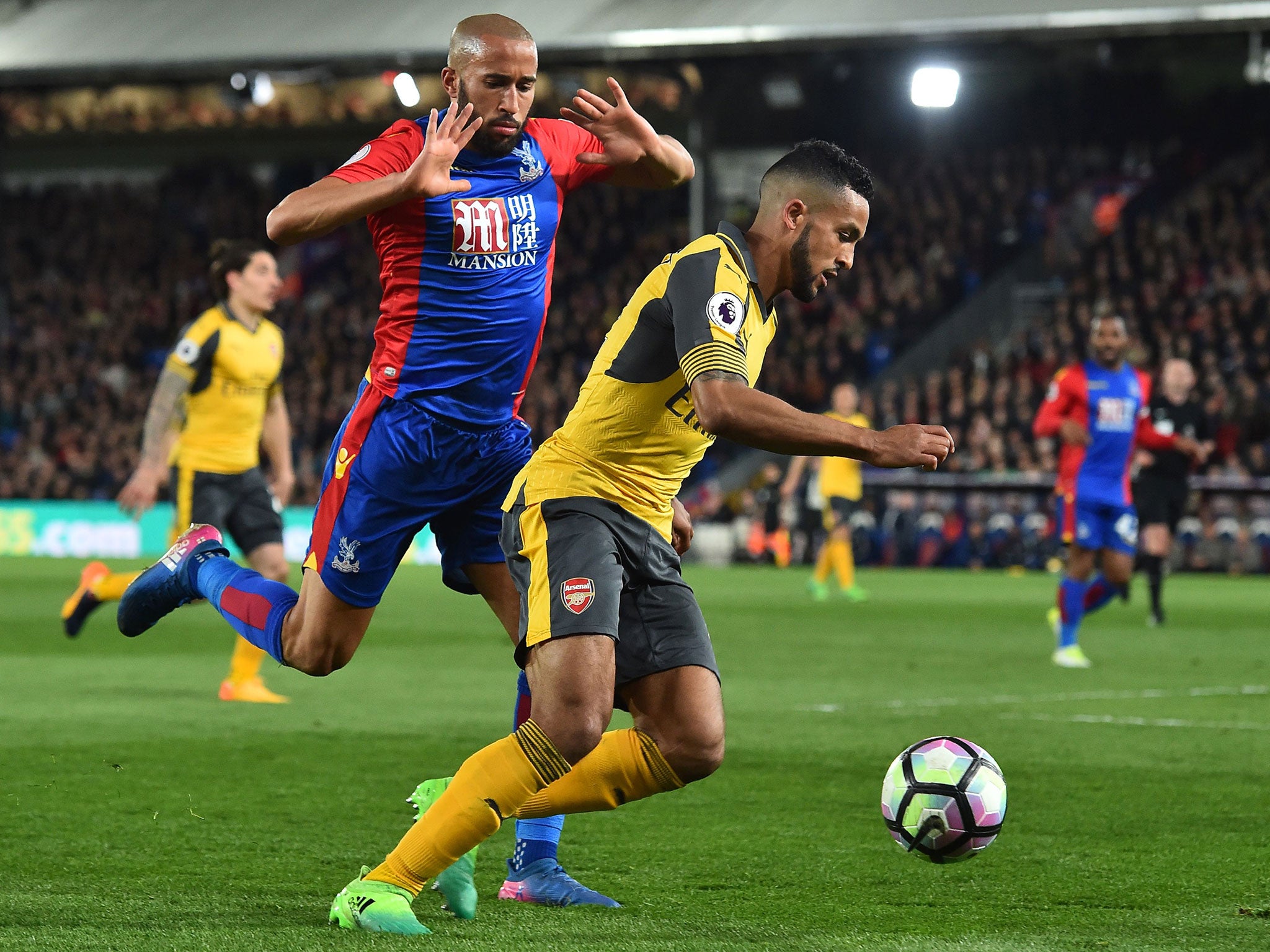 Walcott attempts to take the ball past Townsend