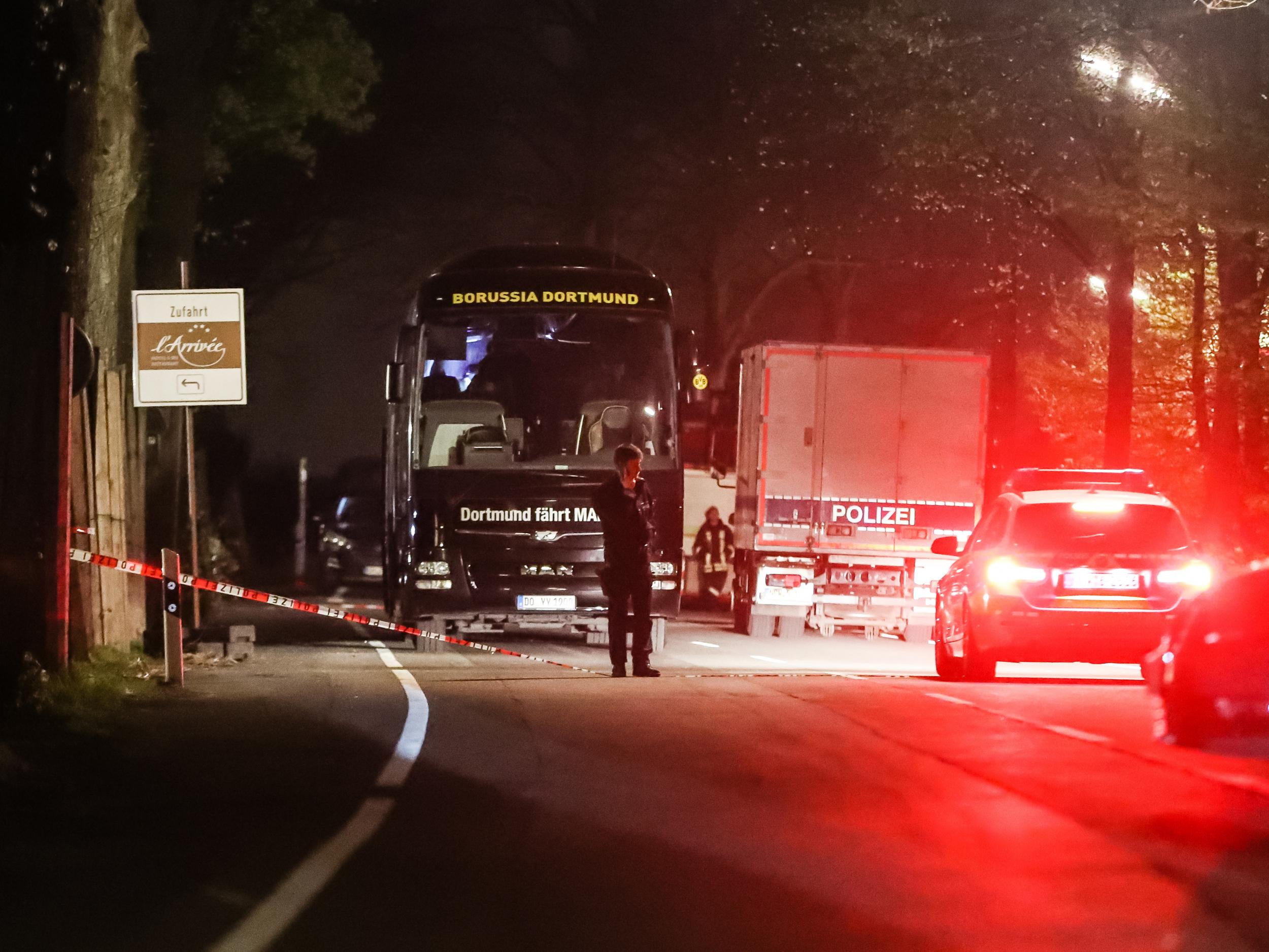 Police stand near the team bus after the attack