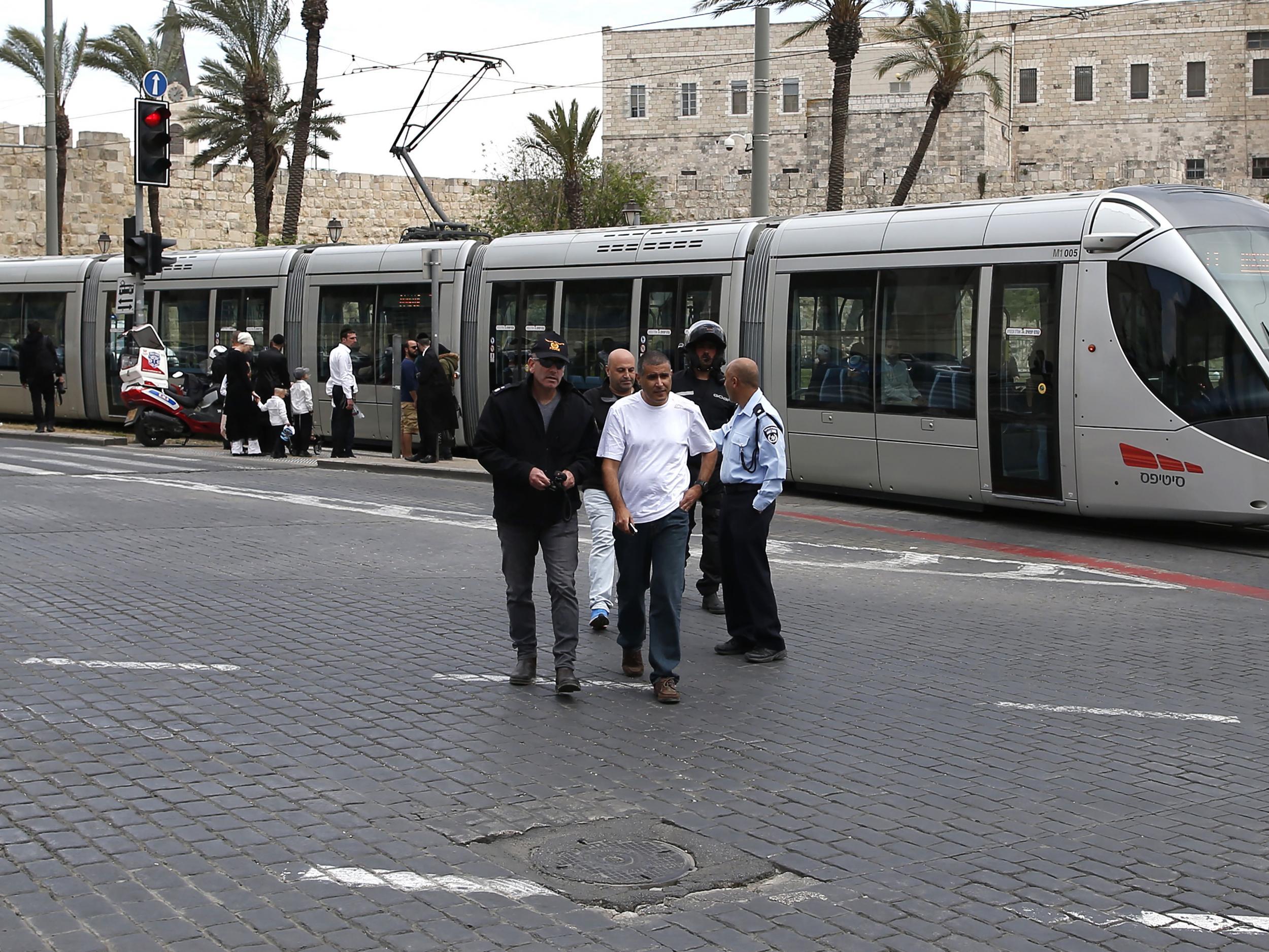 Israeli security forces gathering at the site where a British woman was killed on the light rail near Jerusalem's Old City