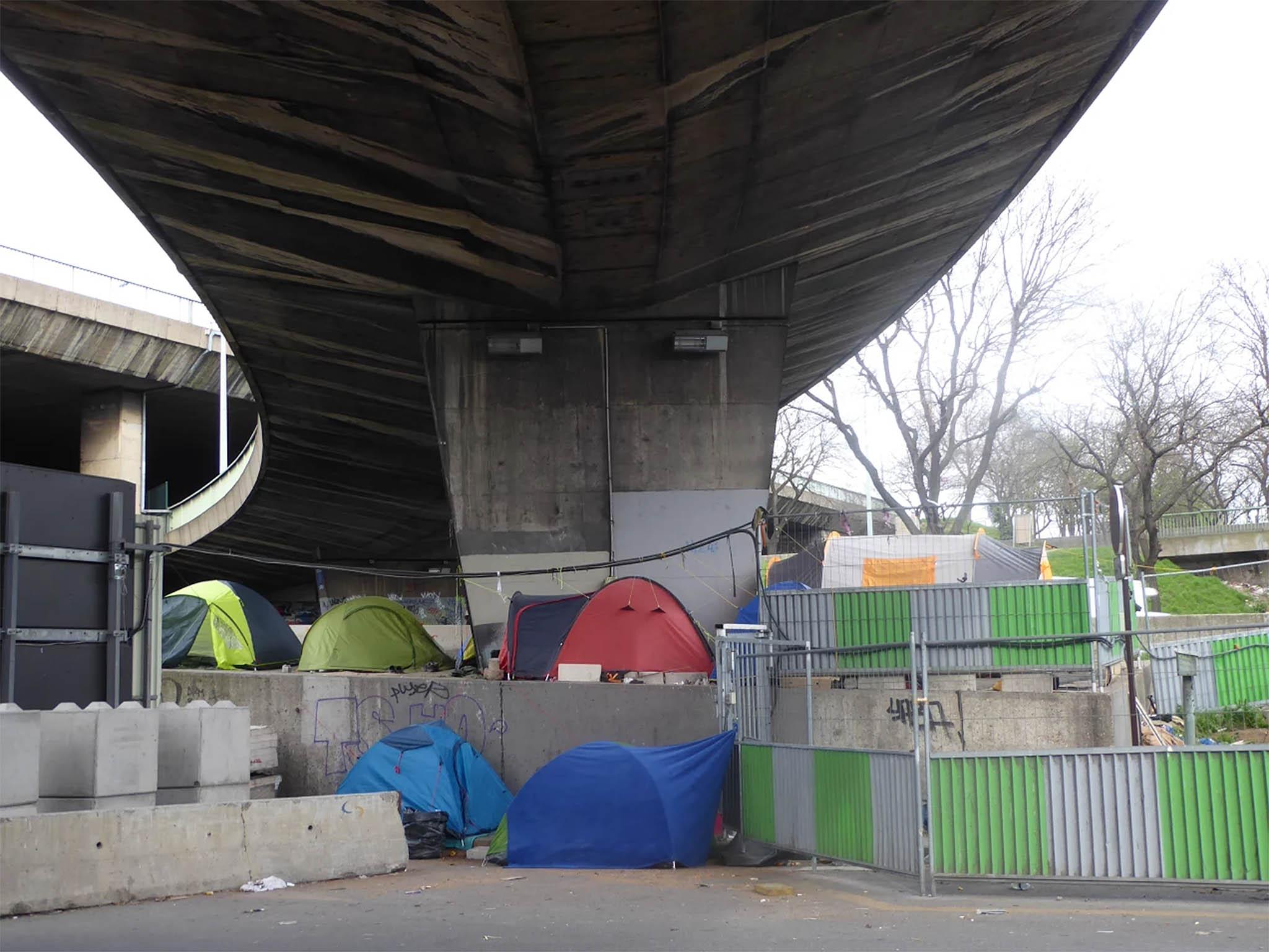 A longer-term camp below a flyover near Porte de la Chapelle