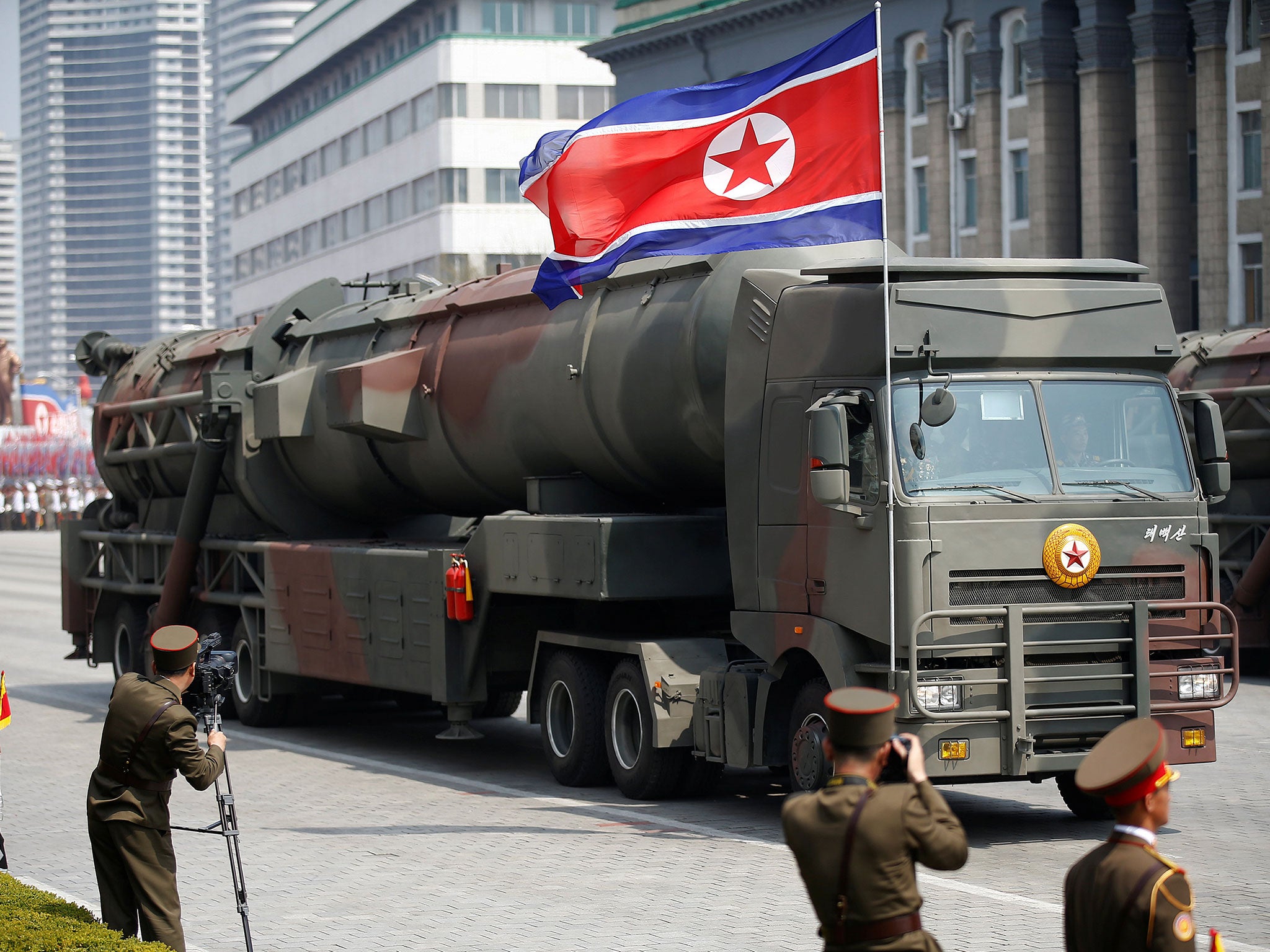 Missiles are driven past Kim Jong-un and other high ranking officials during a military parade marking the Day of the Sun in Pyongyang on Saturday