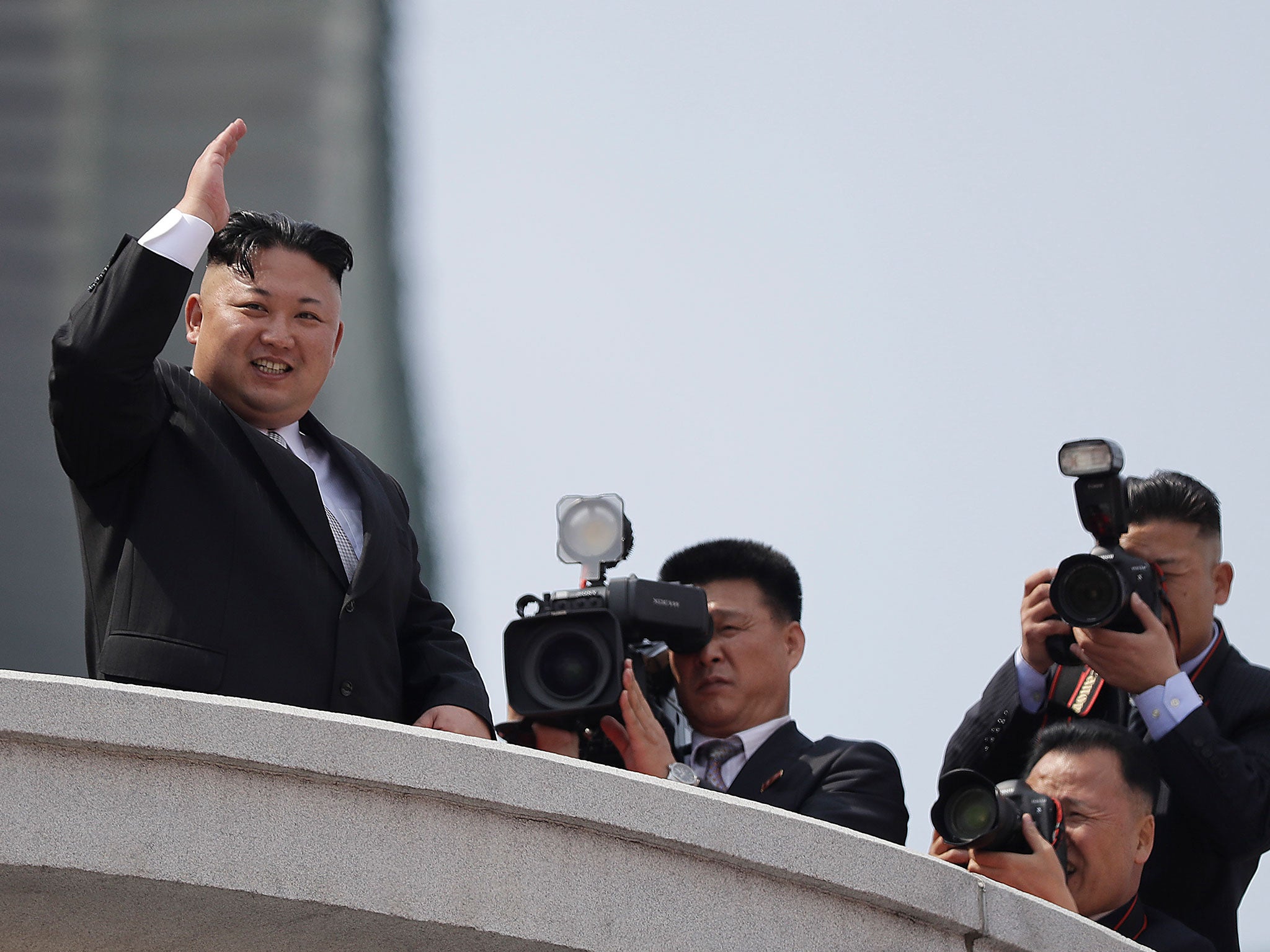 North Korean leader Kim Jong-un waves during a military parade on 15 April 2017