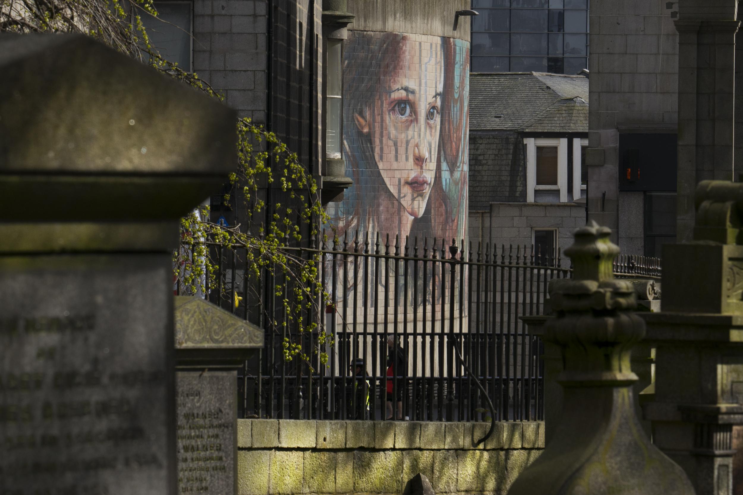 German duo Herakut's haunting image of a Scottish girl extending an arm to people fleeing war