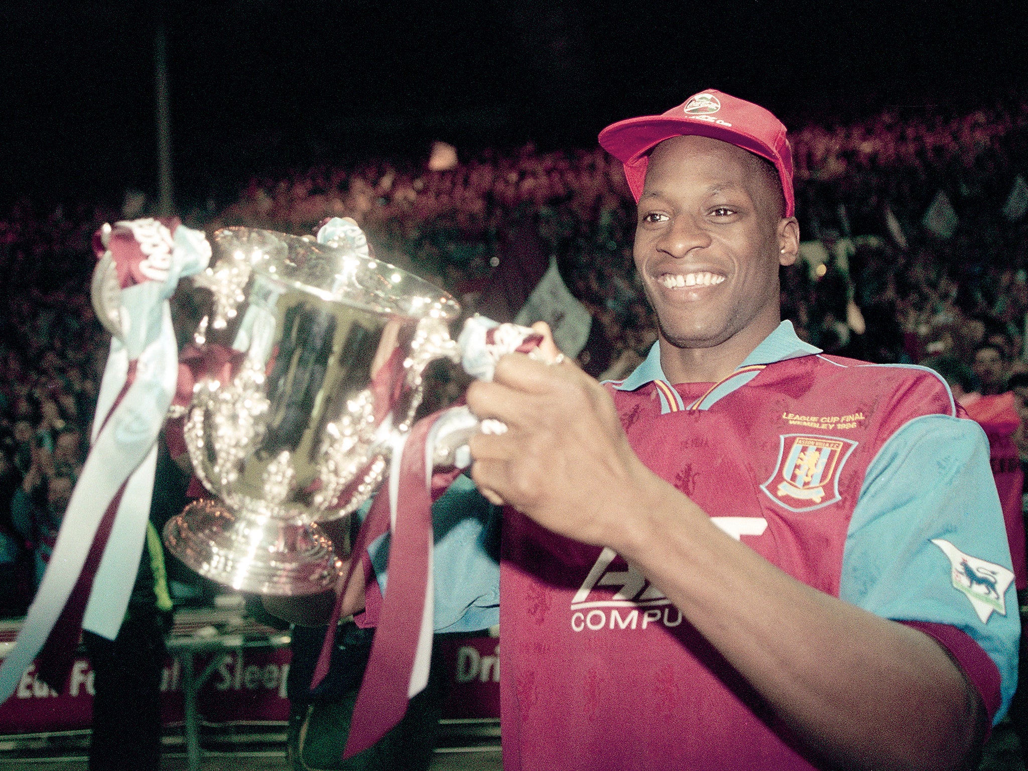 Aston Villa defender Ugo Ehiogu holding the trophy after their victory over Leeds United in the Coca Cola League Cup Final at Wembley stadium. Aston Villa won 3-0