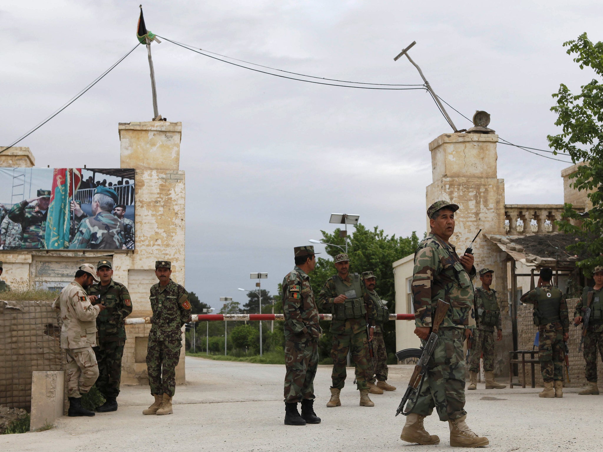 Afghan national army troops keep watch near the site of an ongoing attack on an army headquarters in Mazar-i-Sharif