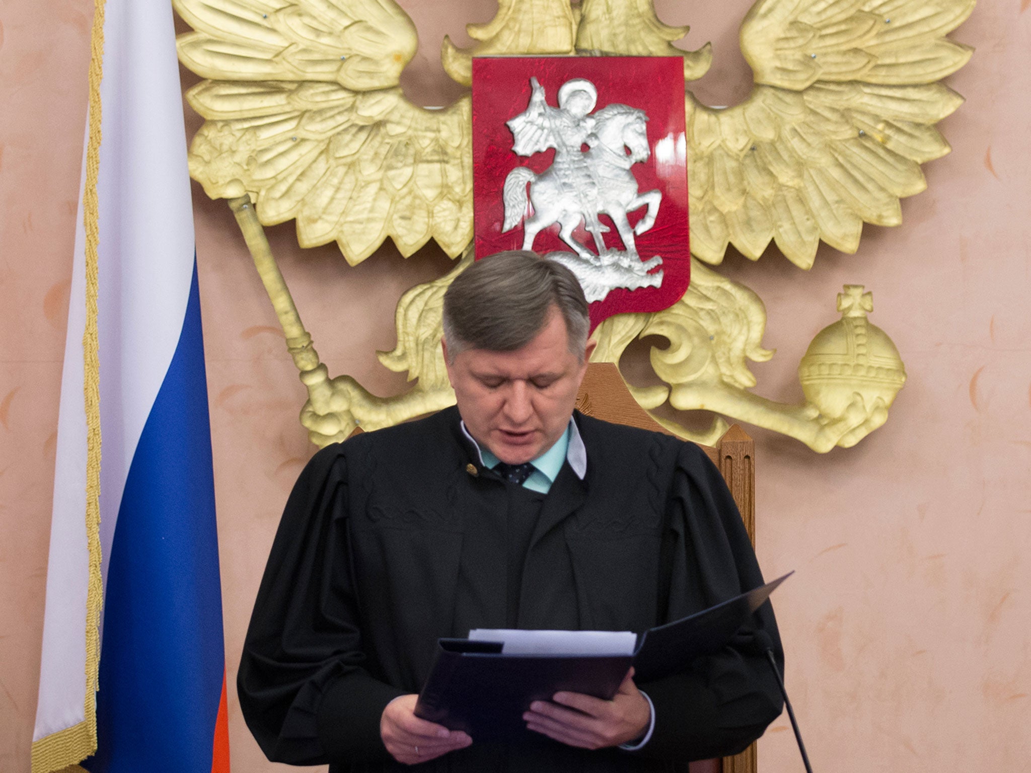 Supreme Court judge Yuri Ivanenko reads the decision in a courtroom in Moscow Thursday