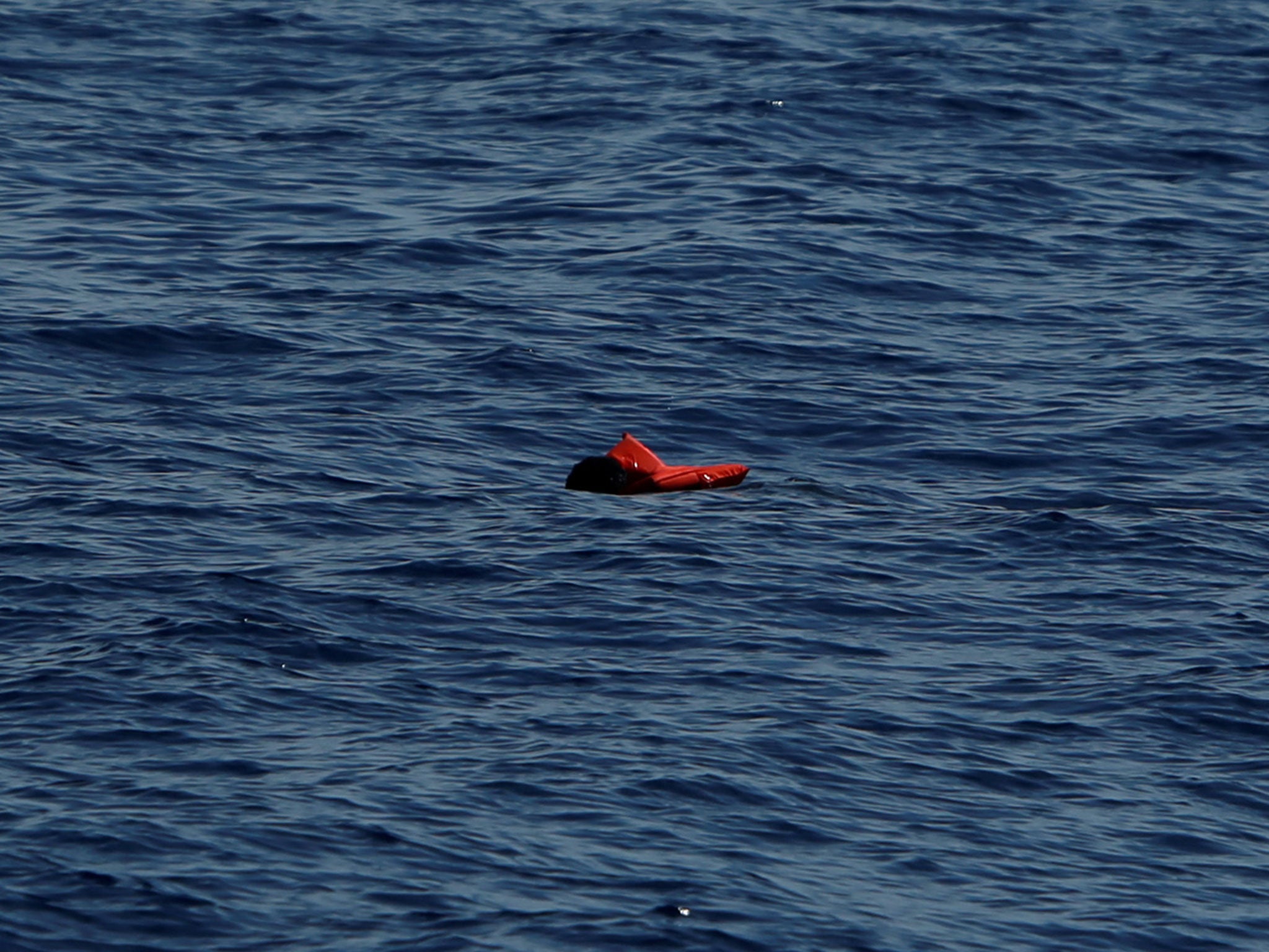 A dead man in a life jacket floats in the Mediterranean Sea after a boat disaster off the coast of Libya on 16 April