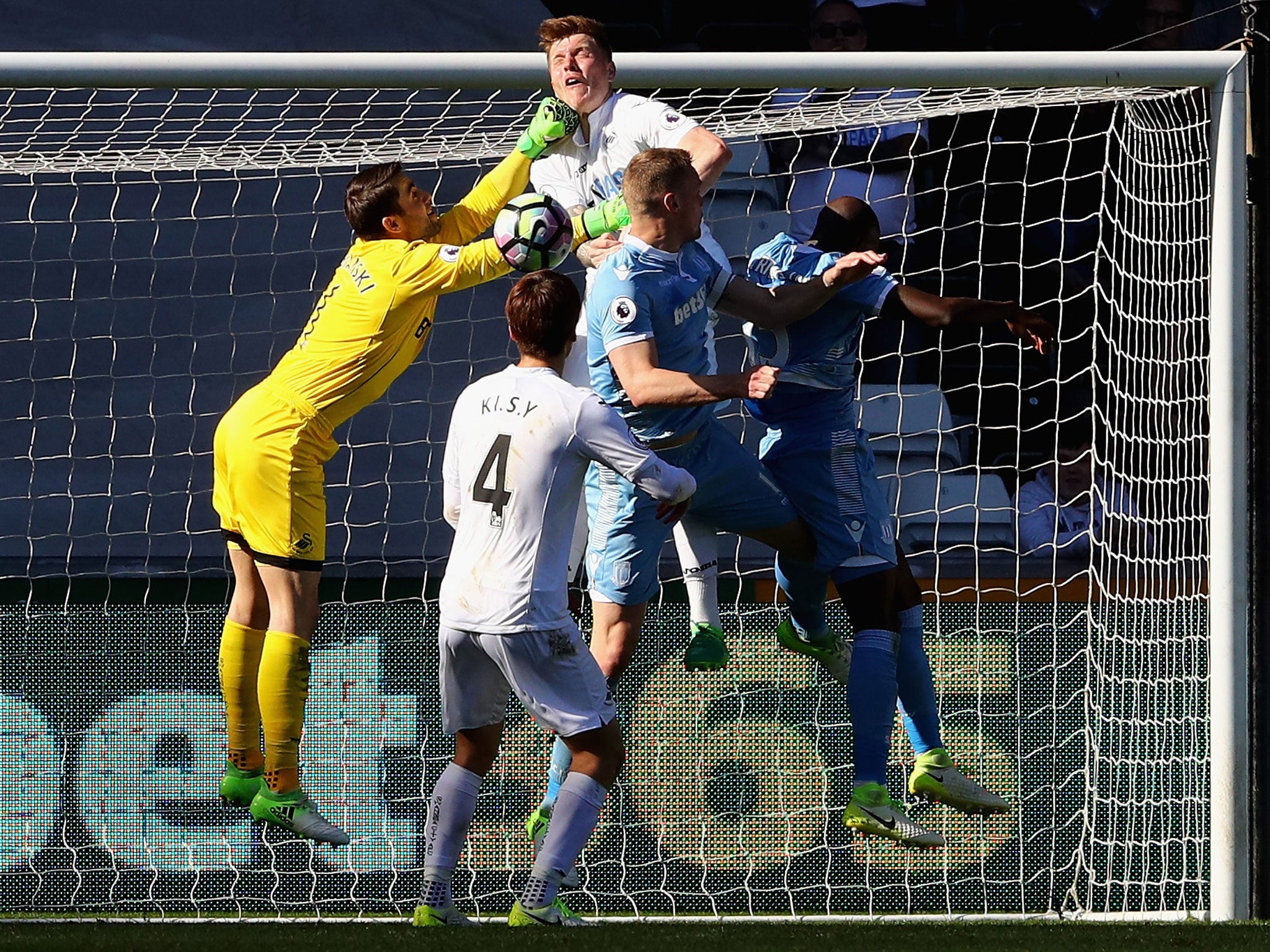 Lukasz Fabianski challenges for a corner