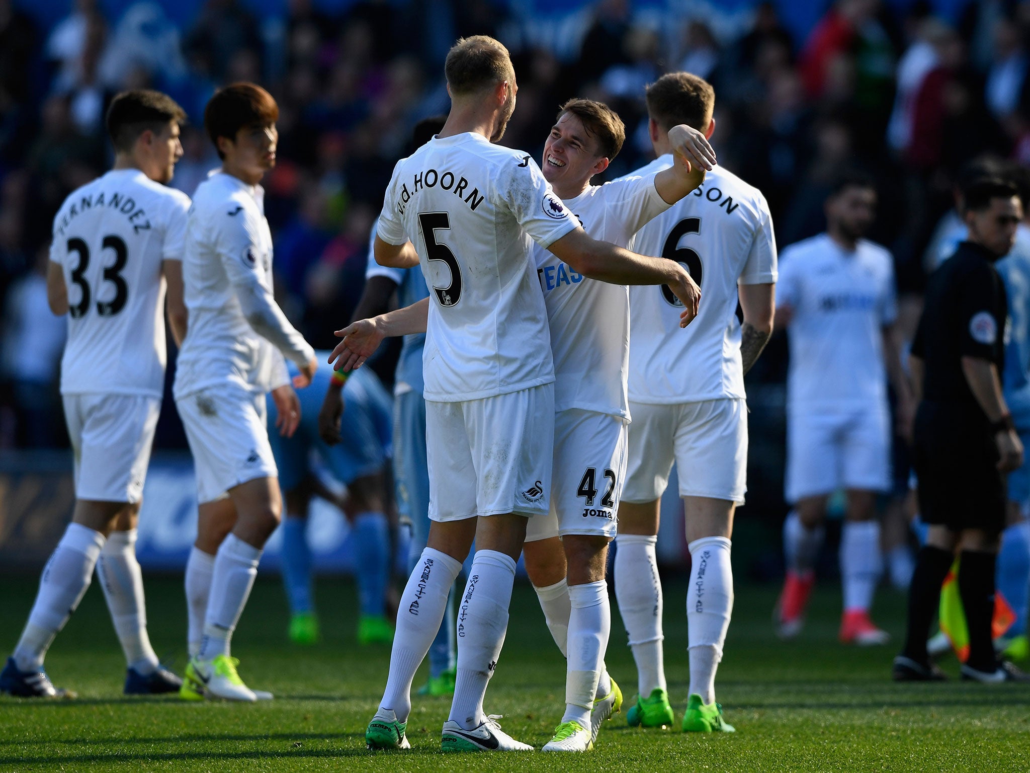 Carroll and Mike van der Hoorn celebrate after the final whistle