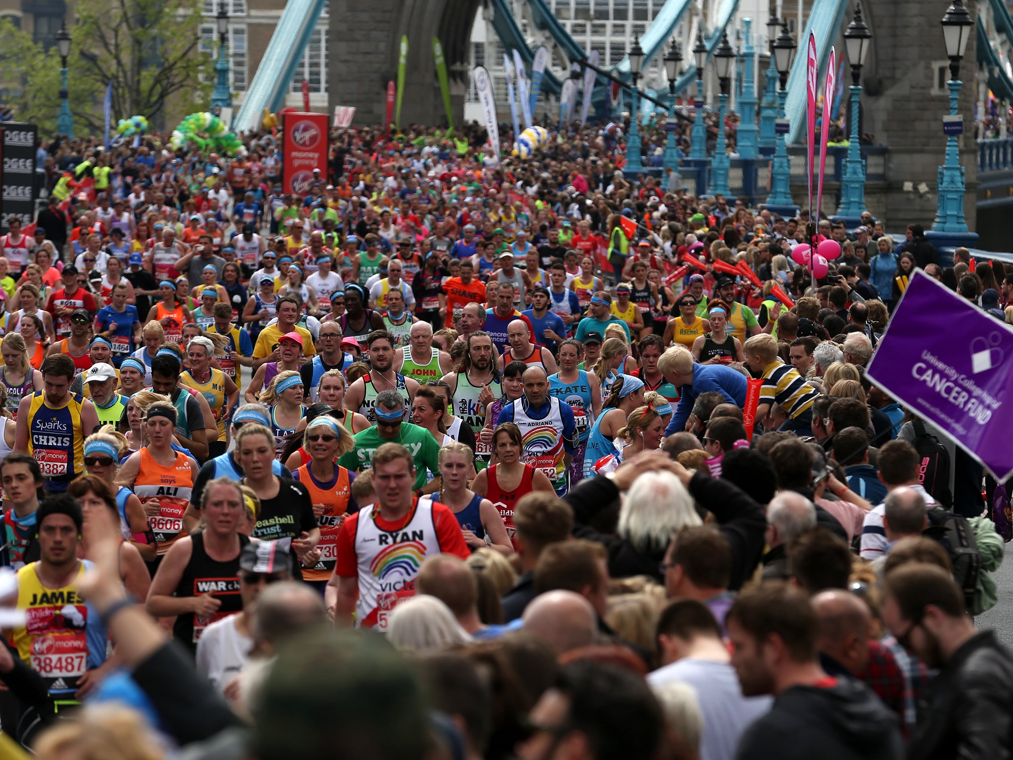 Runners make their way off Tower Bridge during the Virgin Money London Marathon, London