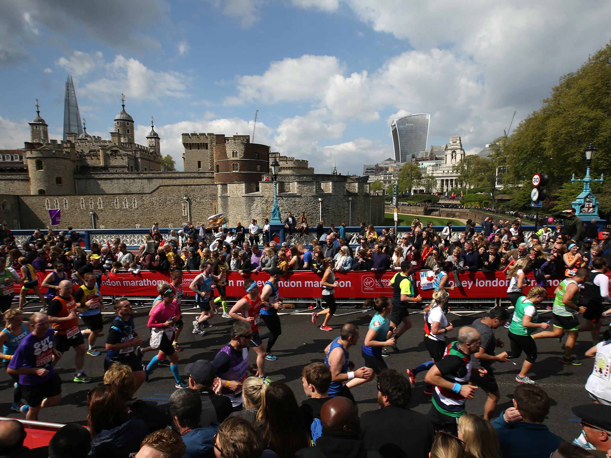 Runners make their way off Tower Bridge during the 2017 London Marathon