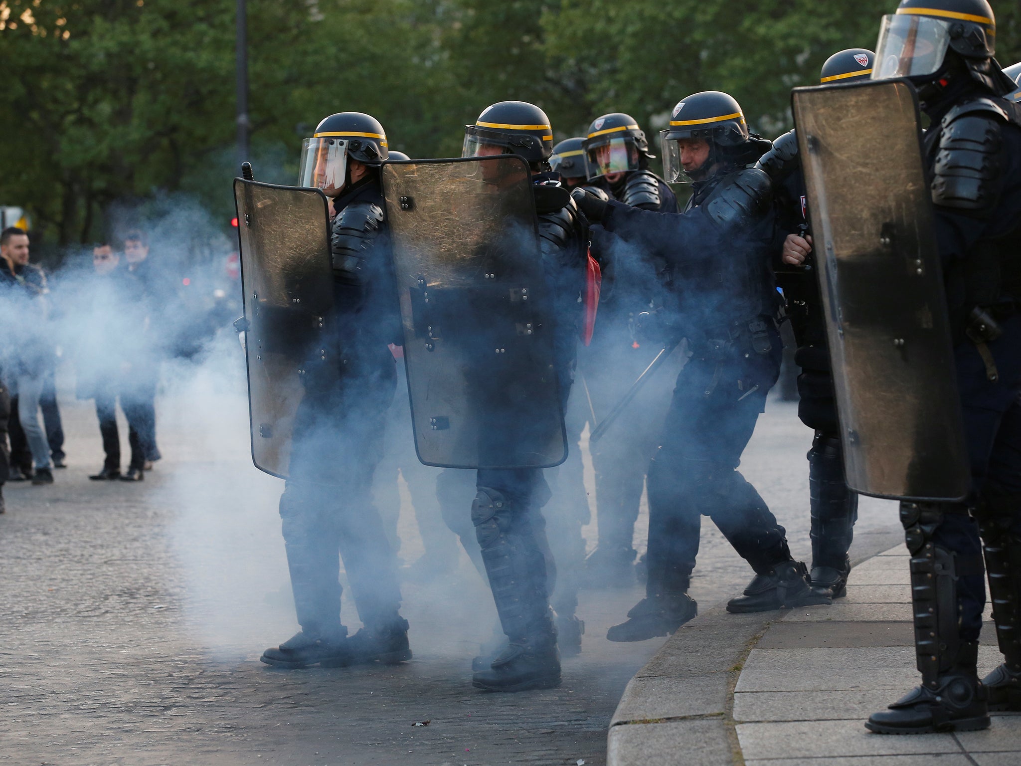 French riot police clash with demonstrators after partial results in the first round of 2017 French presidential election, in Paris.