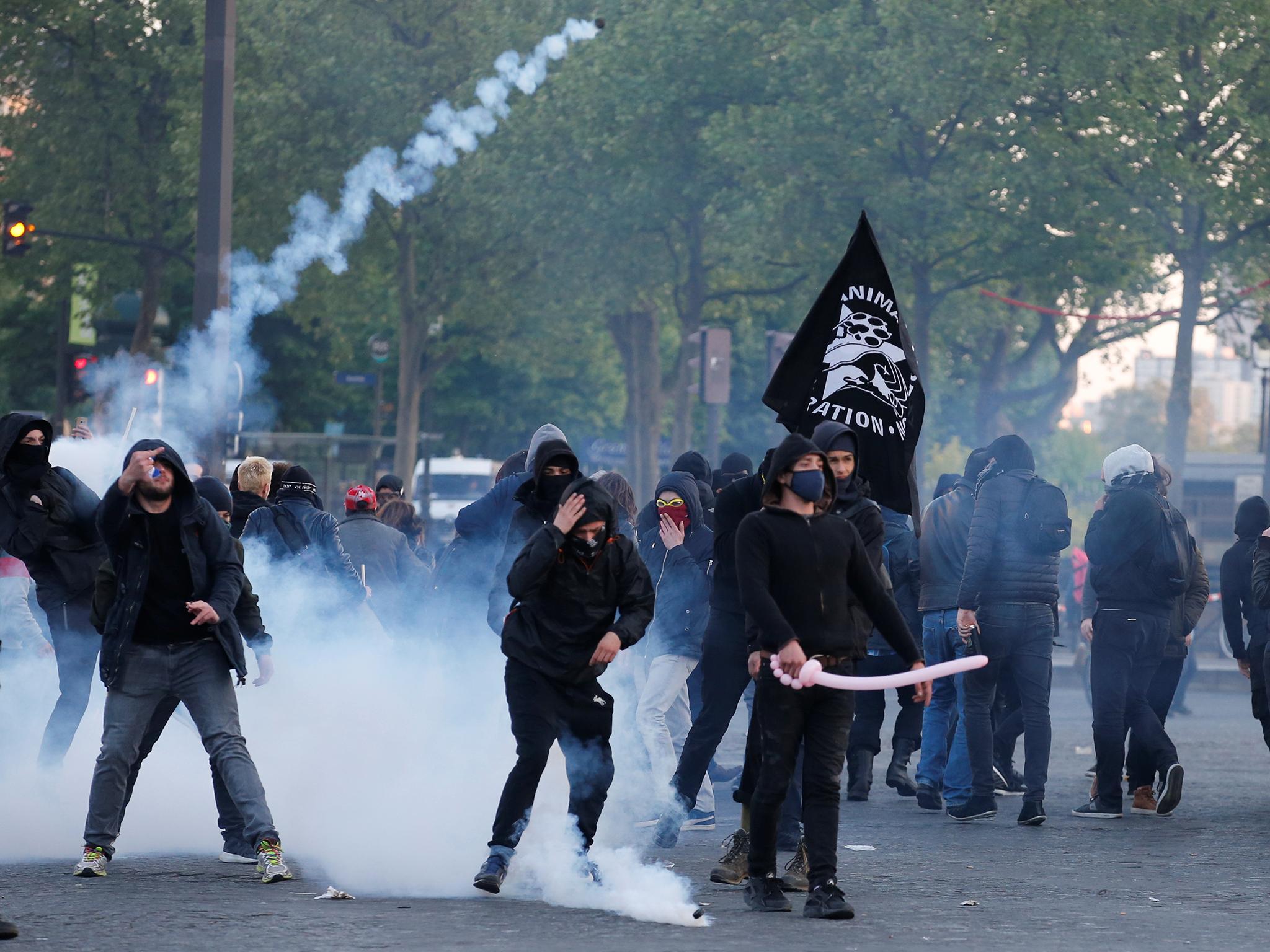 Demonstrators clash with French riot police after partial results in the first round of 2017 French presidential election, in Paris.