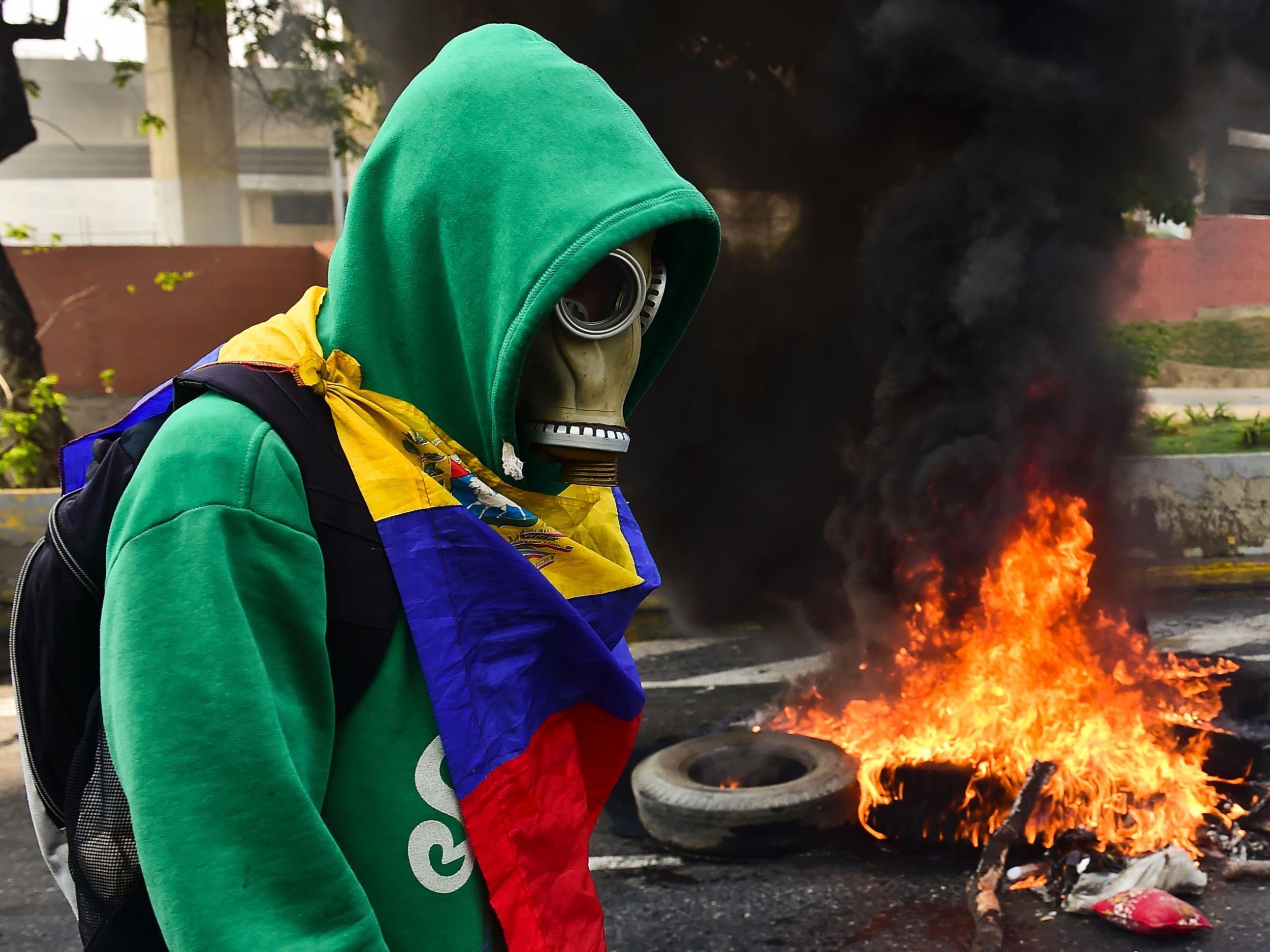 A protester clashes with police in Caracas