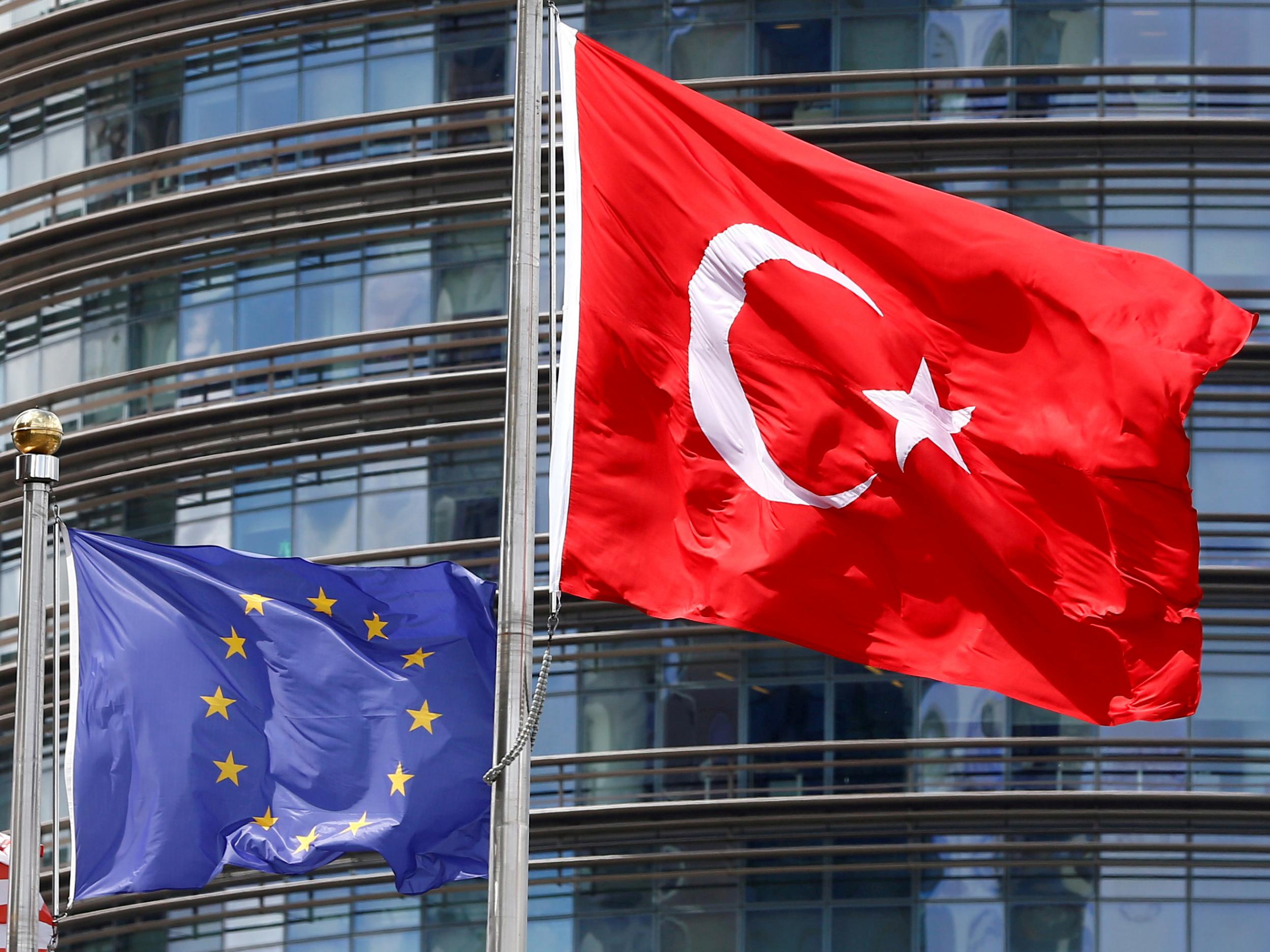 A European Union and Turkish flag fly outside a hotel in Istanbul