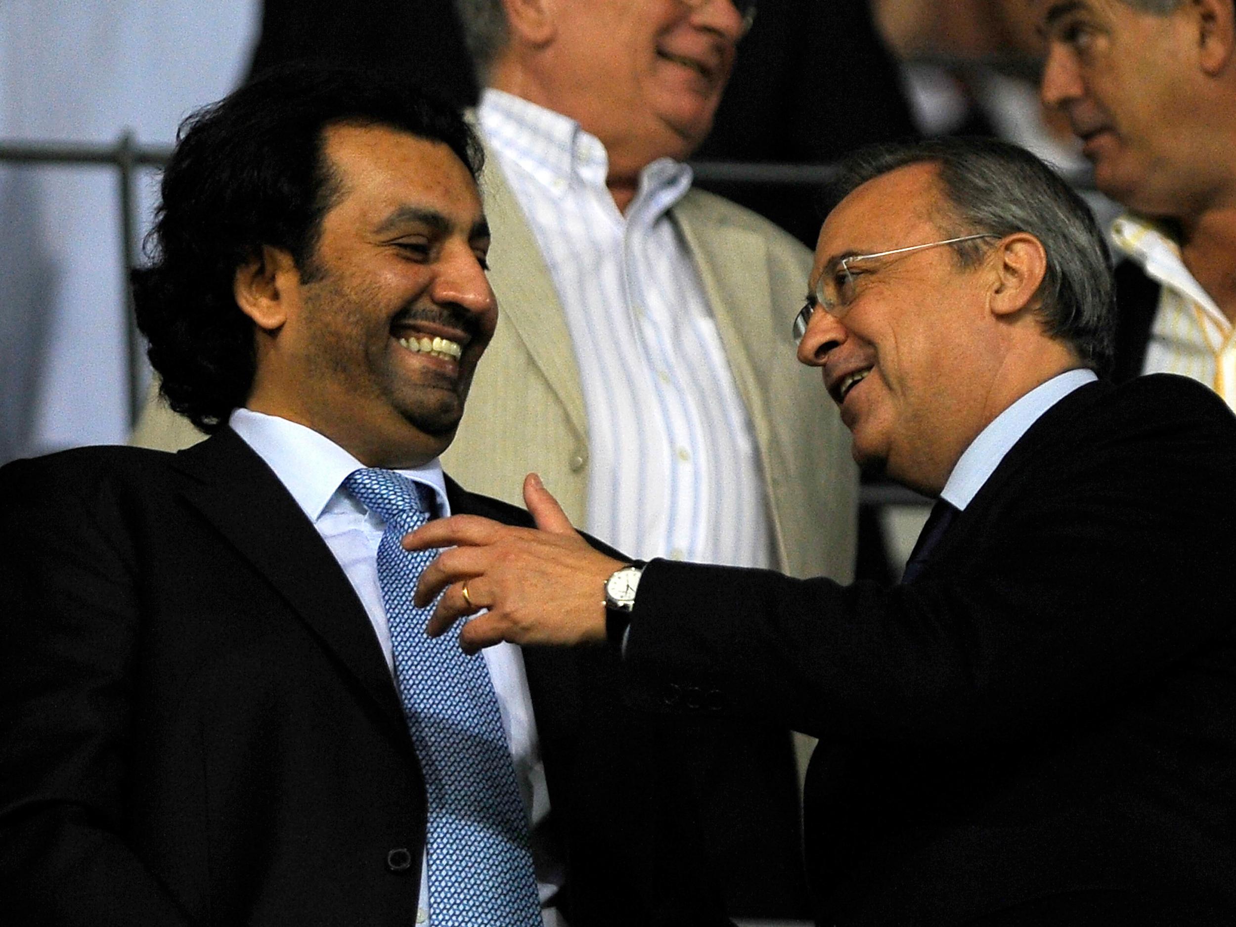 Sheikh Al-Thani, Malaga's owner, jokes with Real Madrid president Florentino Perez