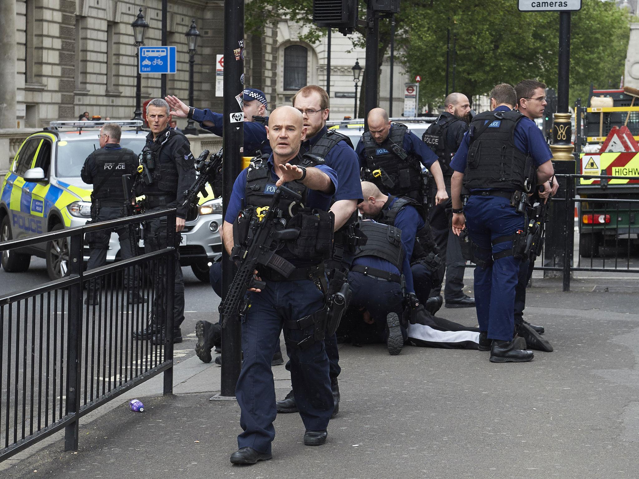 Firearms officiers from the British police arrest a man on Whitehall near the Houses of Parliament (NIKLAS HALLE&amp;#039;N/AFP/Getty Images)