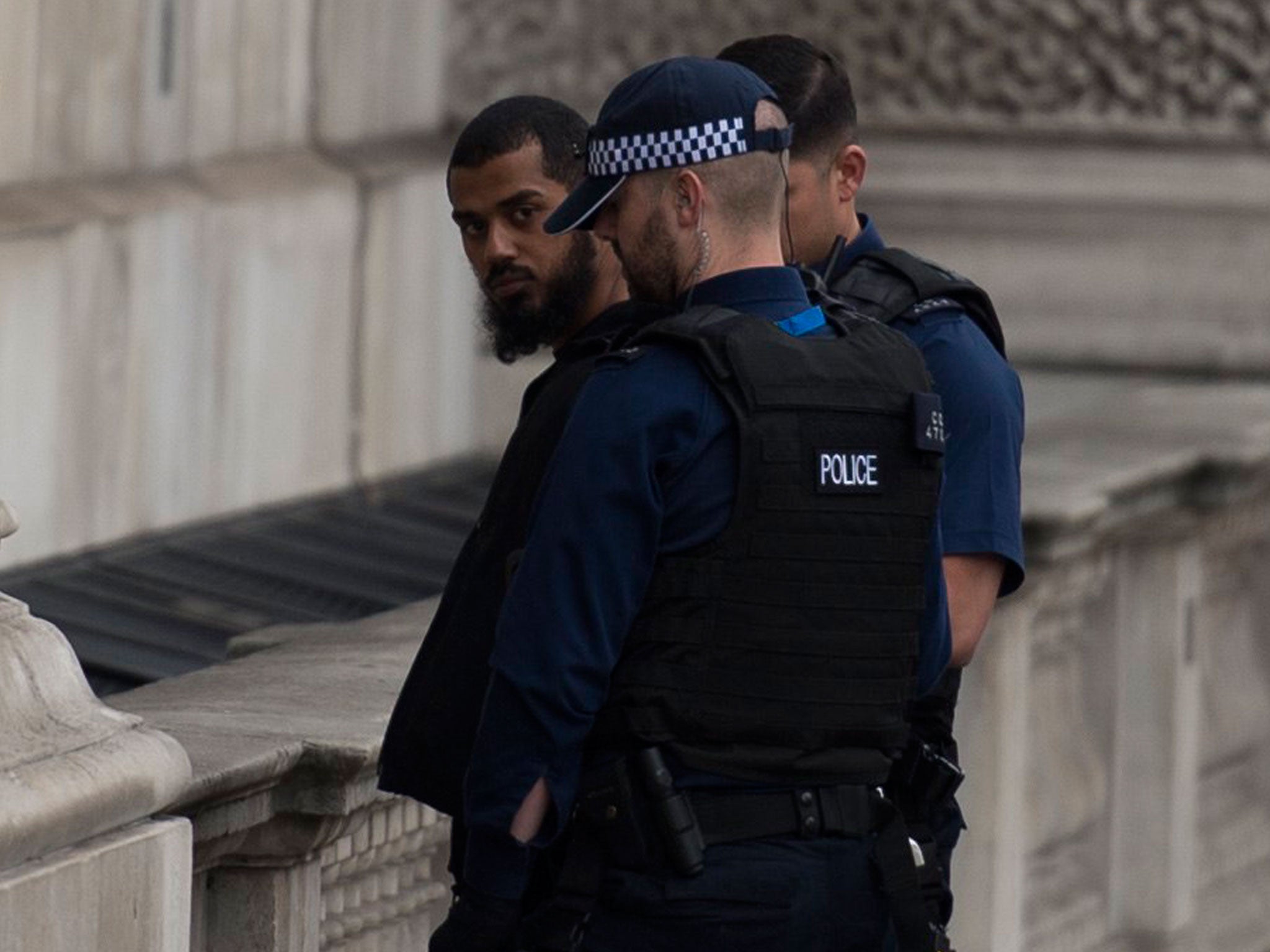 Police detain a man following an incident in Whitehall; a bag and three knives were found at the scene