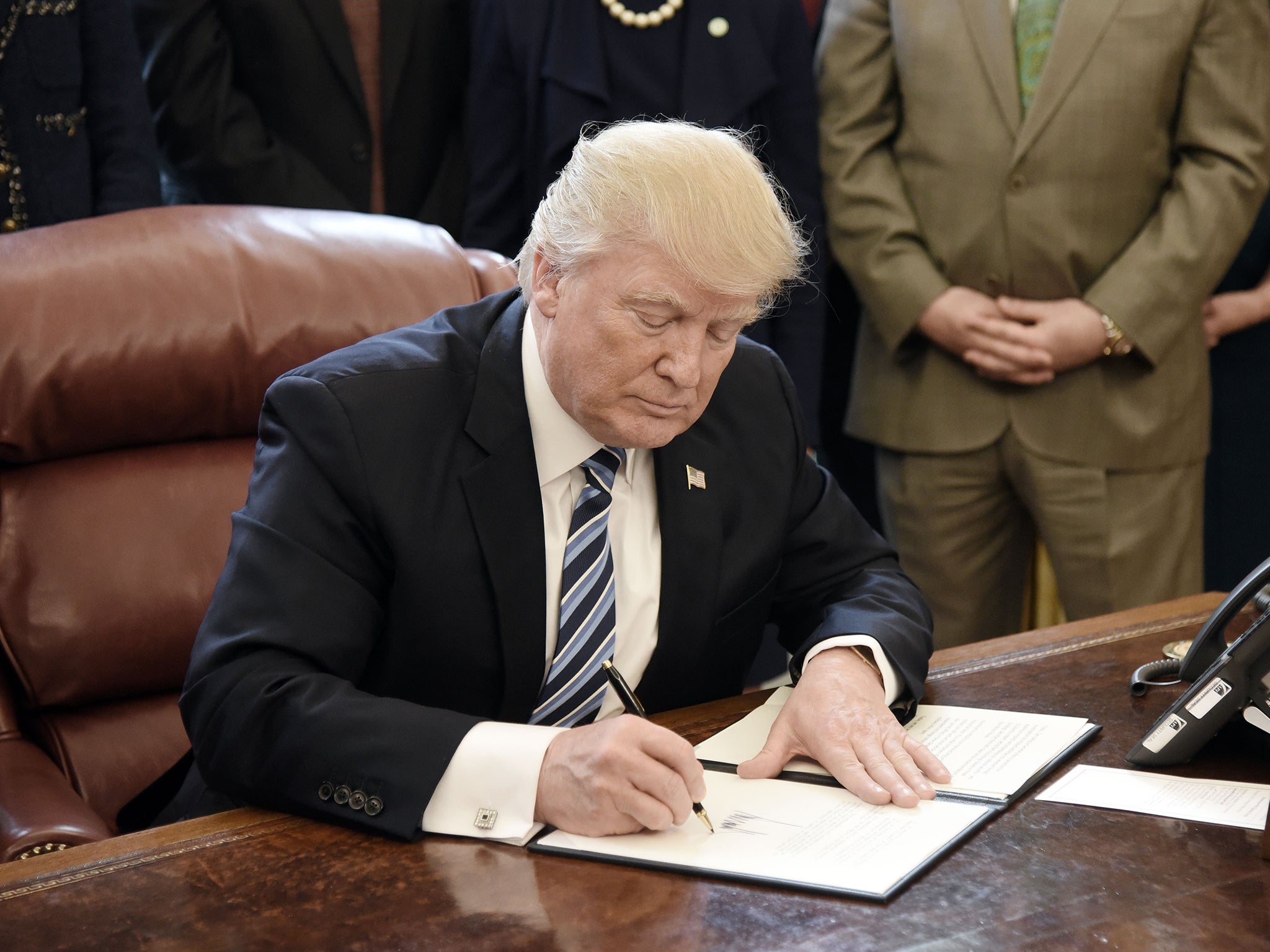 U.S. President Donald Trump signs a Memorandum on Aluminum Imports and Threats to National Security in the Oval Office