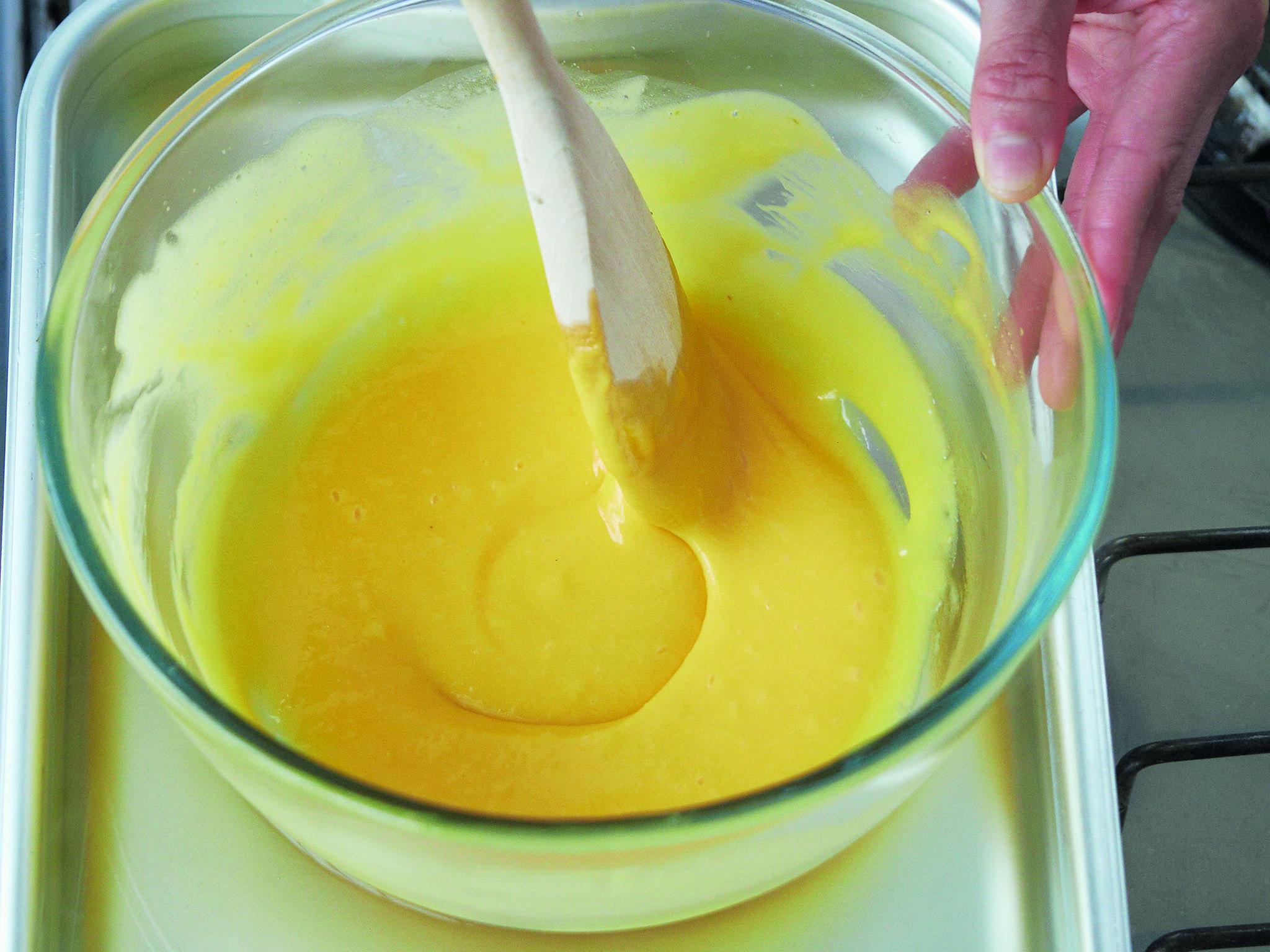 4. Stirring the egg yolk, butter and reduction mix over the bain-marie until it starts to thicken