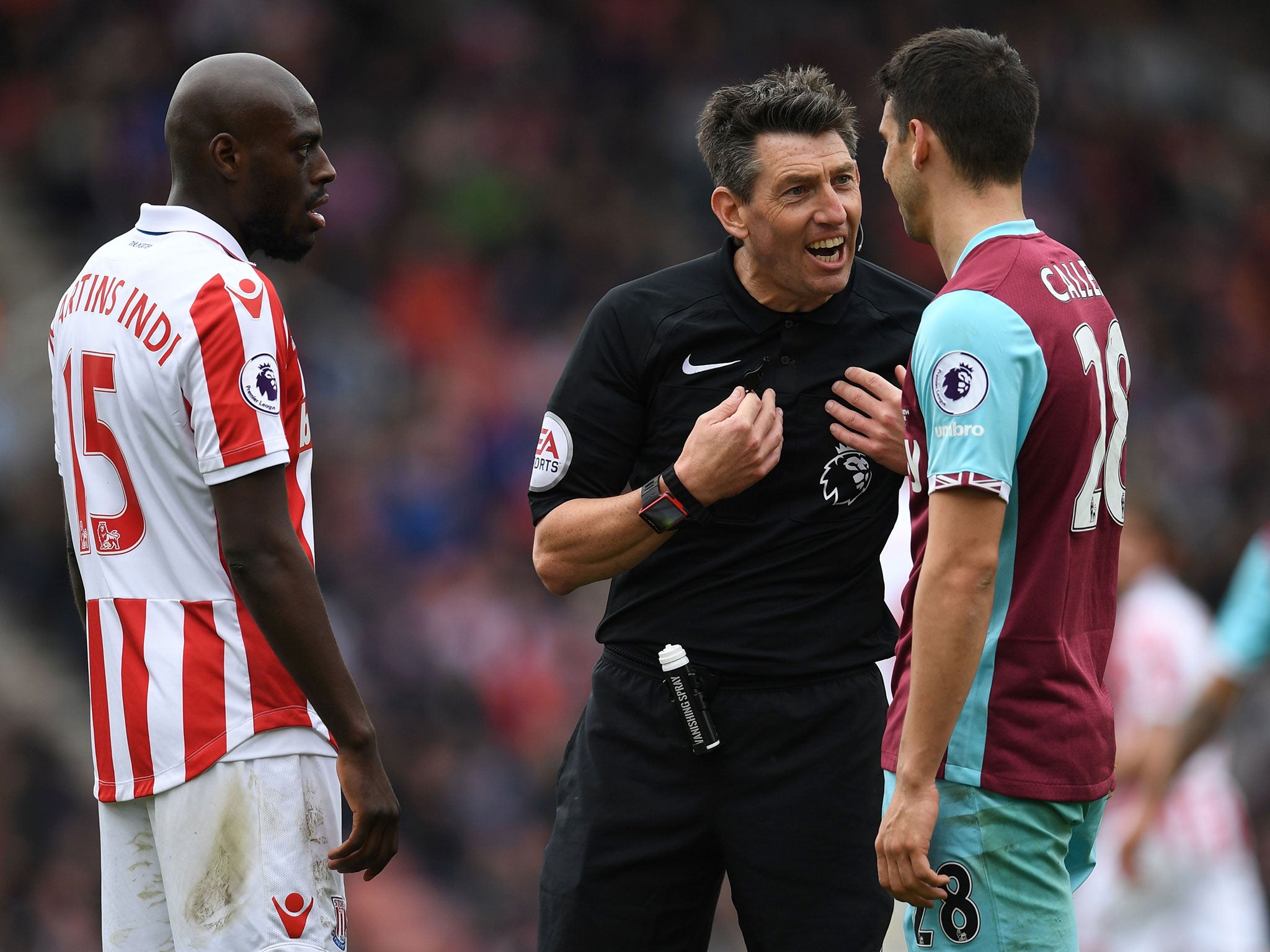 Referee Lee Probert lectures Bruno Martins Indi and Jonathan Calleri