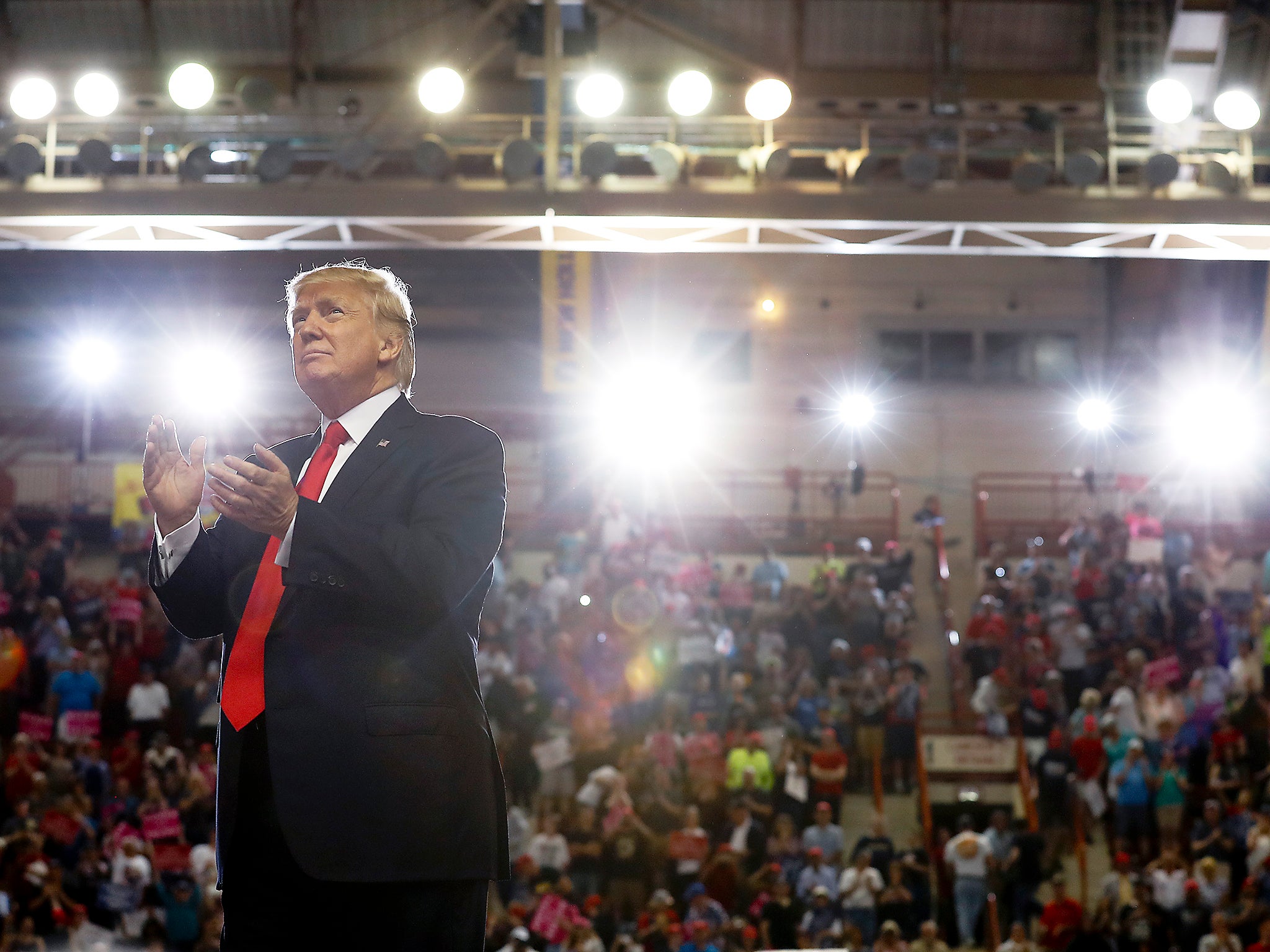 President Donald Trump turns to the audience behind him as he finishes speaking at the Pennsylvania Farm Show Complex and Expo Center in Harrisburg, Pa