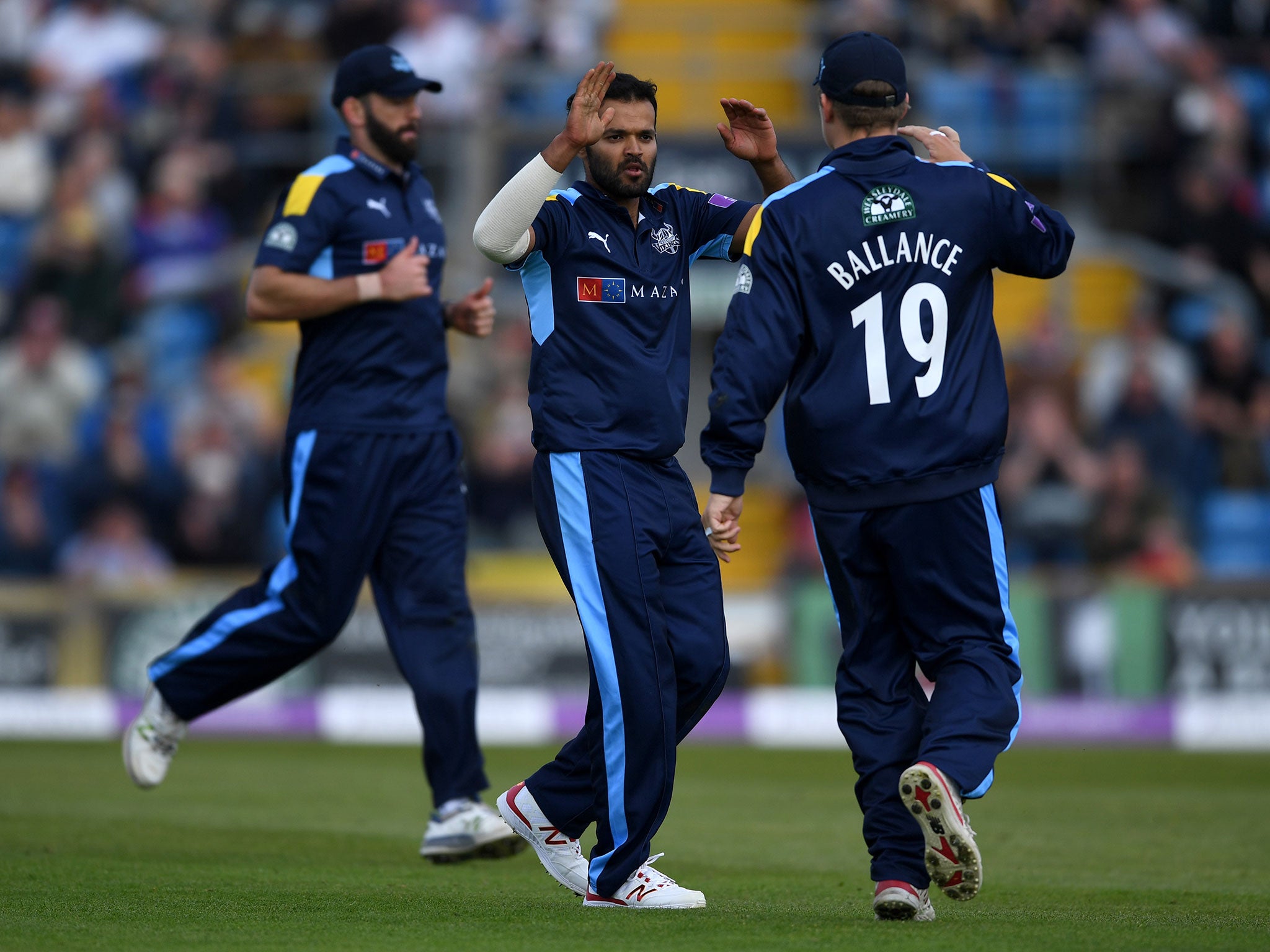 Azeem Rafiq celebrates with team-mates after dismissing Karl Brown