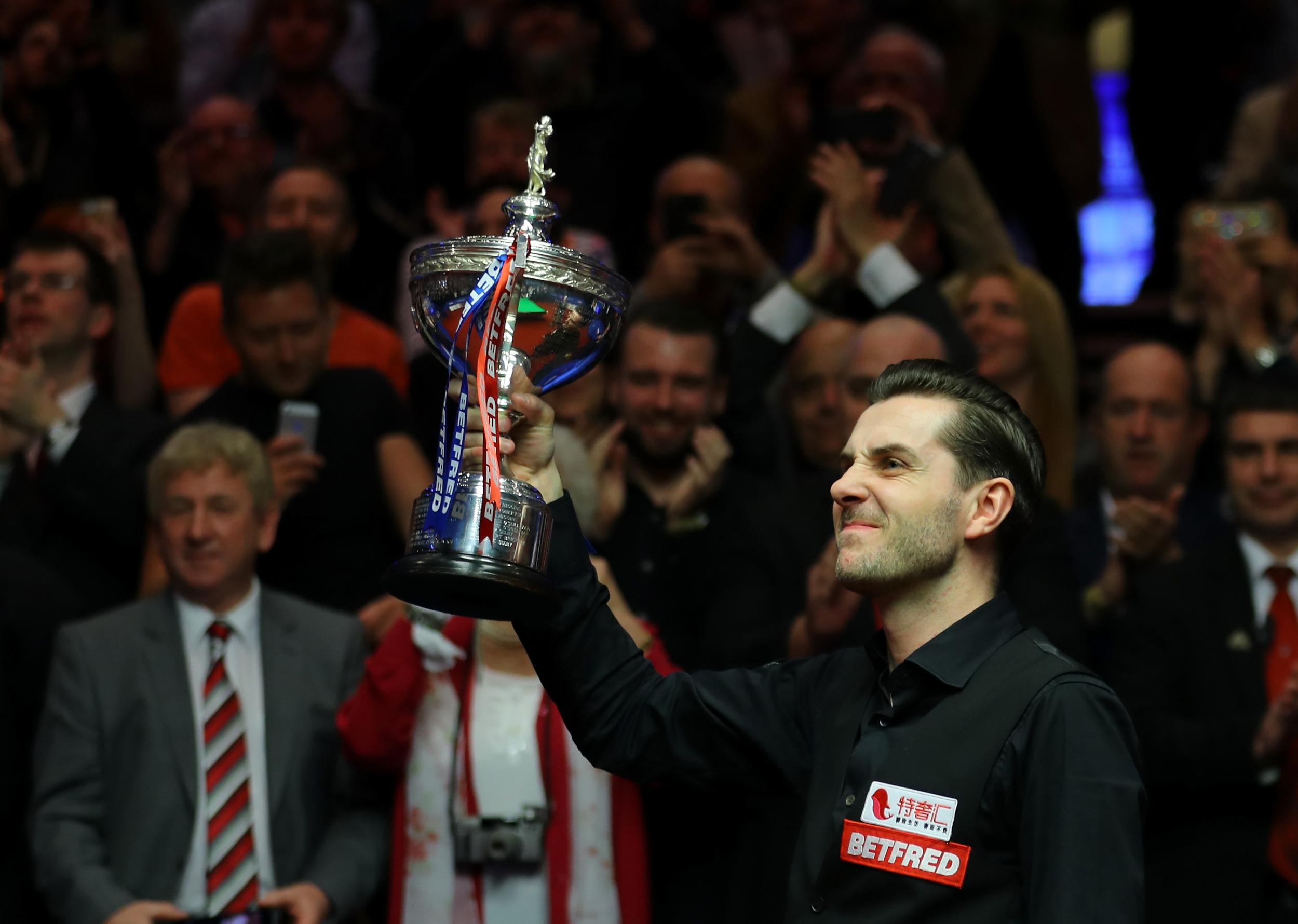 Mark Selby poses with the trophy after beating John Higgins