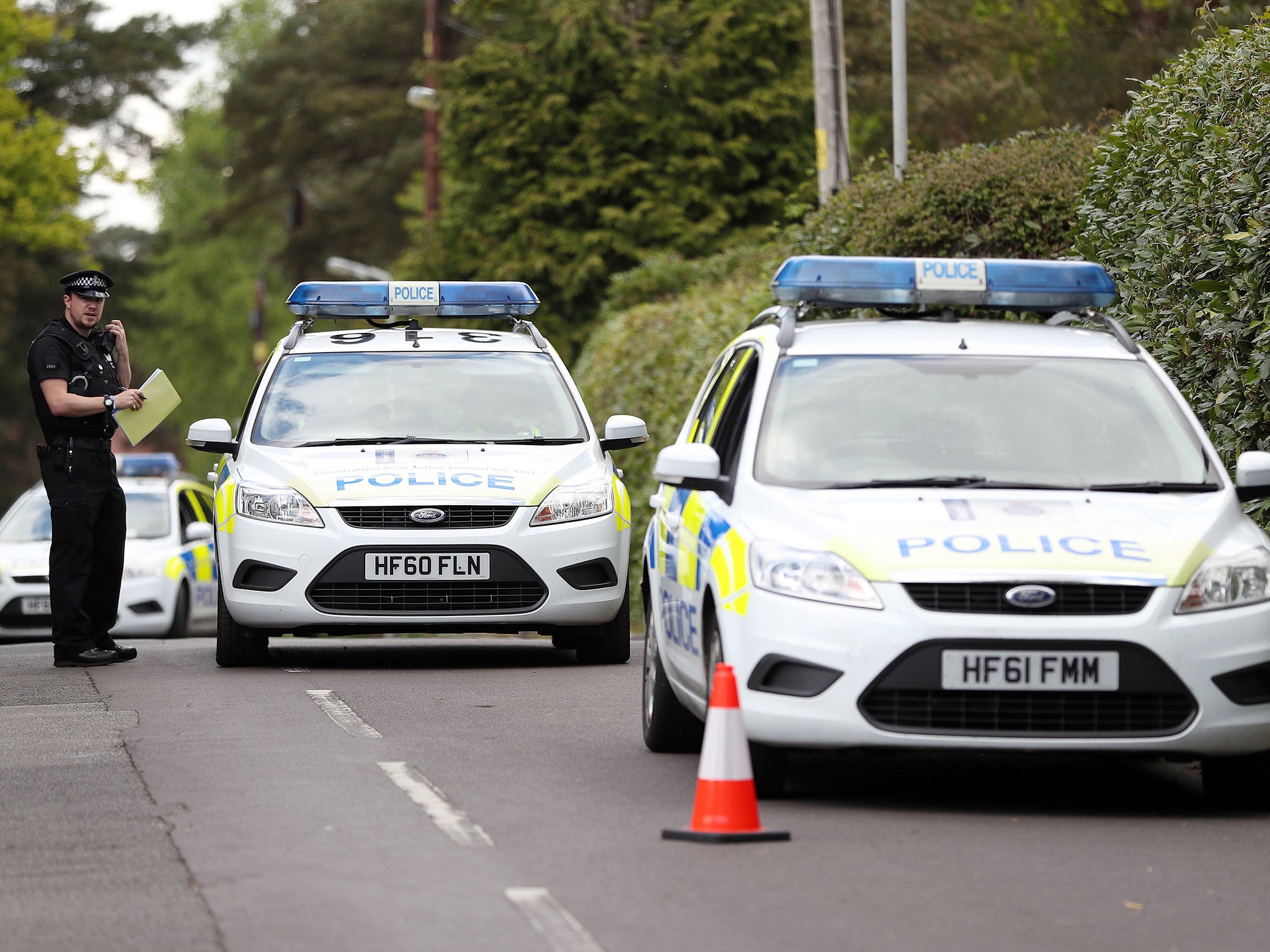 Police presence on David's Lane in St Ives, Ringwood, near to where Guy Hedger was gunned down (PA)