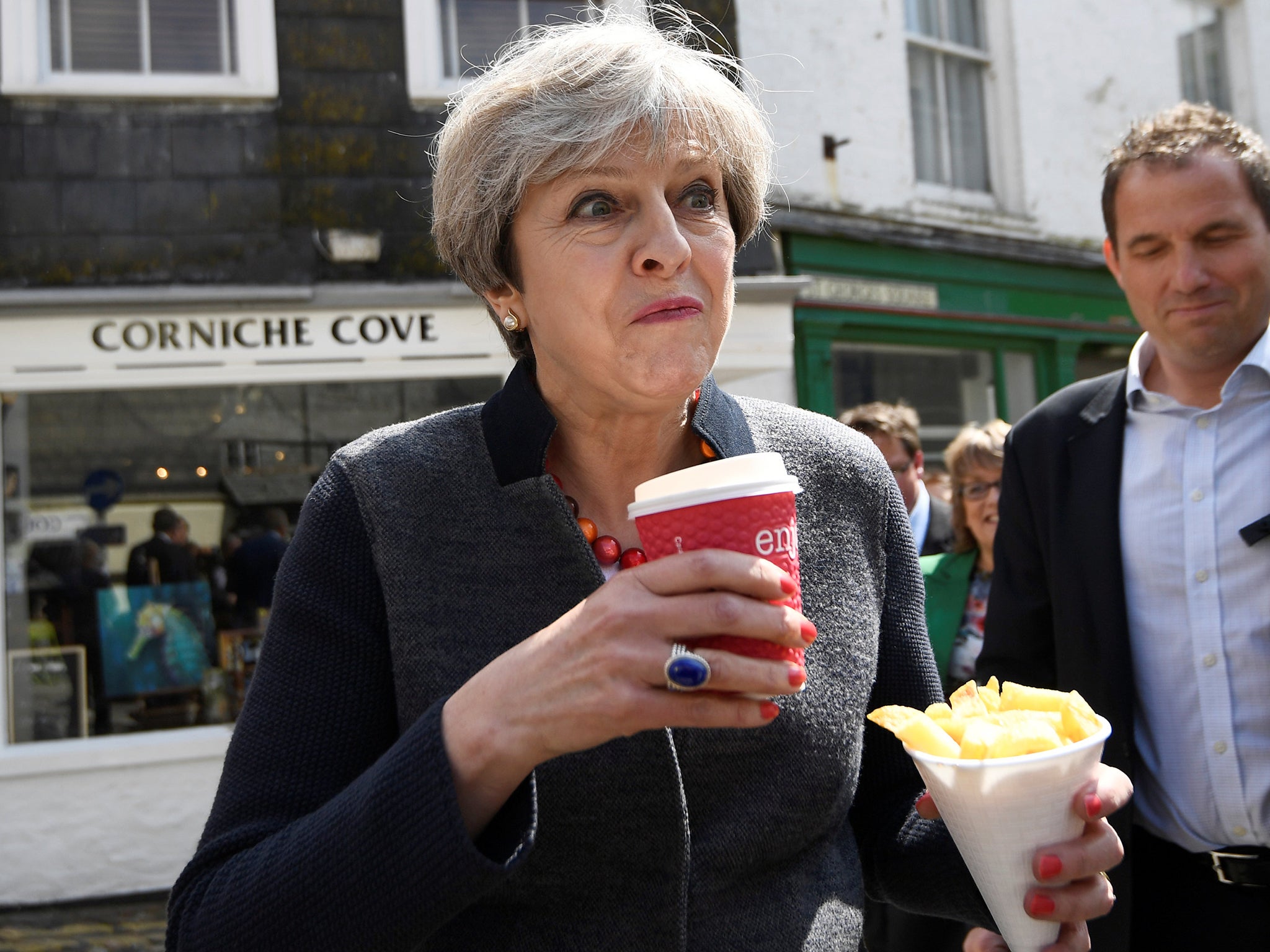 Prime Minister Theresa May having some chips while on a walkabout during a election campaign stop in Mevagissey, Cornwall