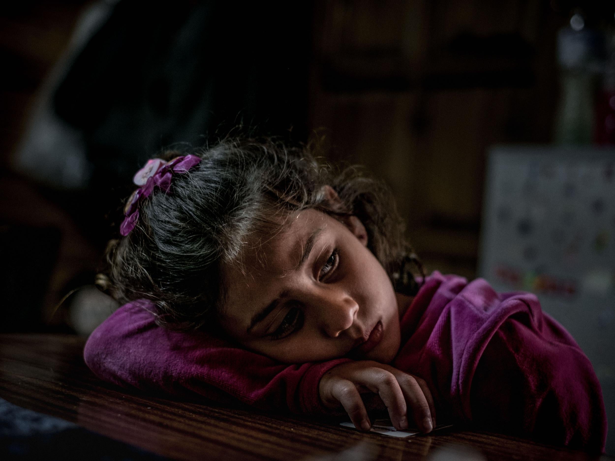 Mariem, 8, a refugee from the Syrian Arab Republic, in her family’s shelter at an open refugee camp run by volunteers in Lesvos, Greece