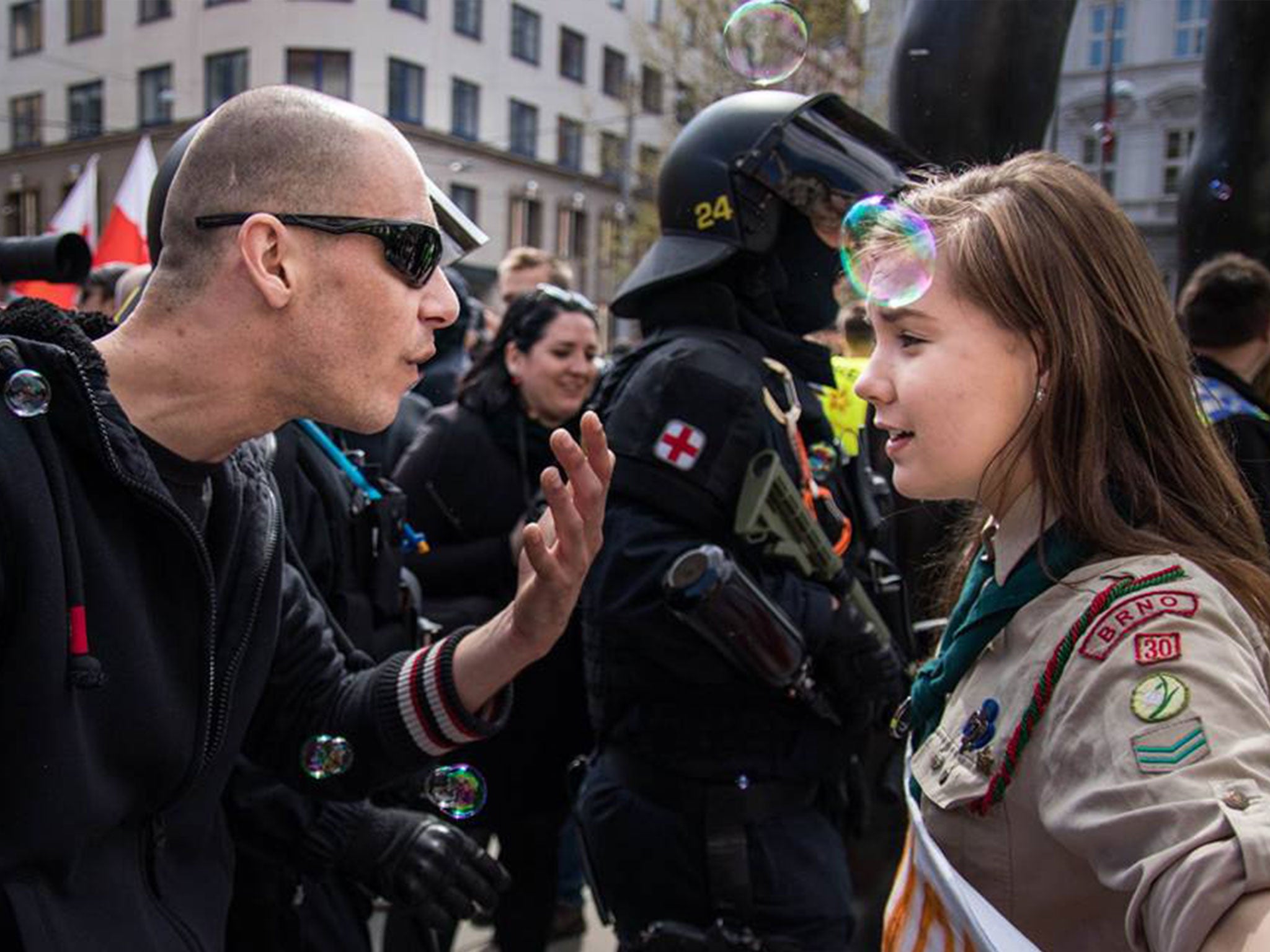 A young girl scout protesting against a far-right march in Brno