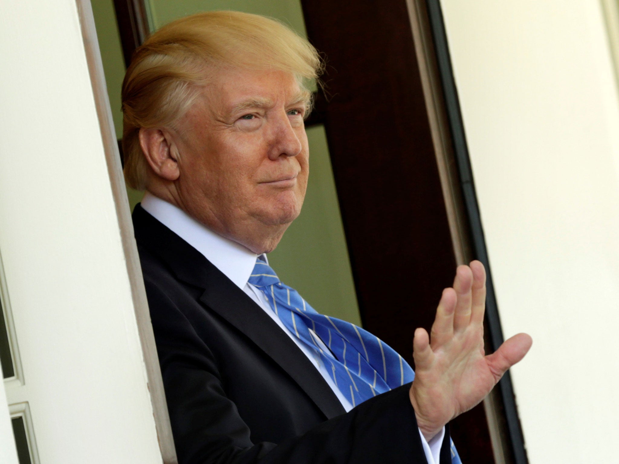 Donald Trump gestures to the media after Palestinian President Mahmoud Abbas left the White House