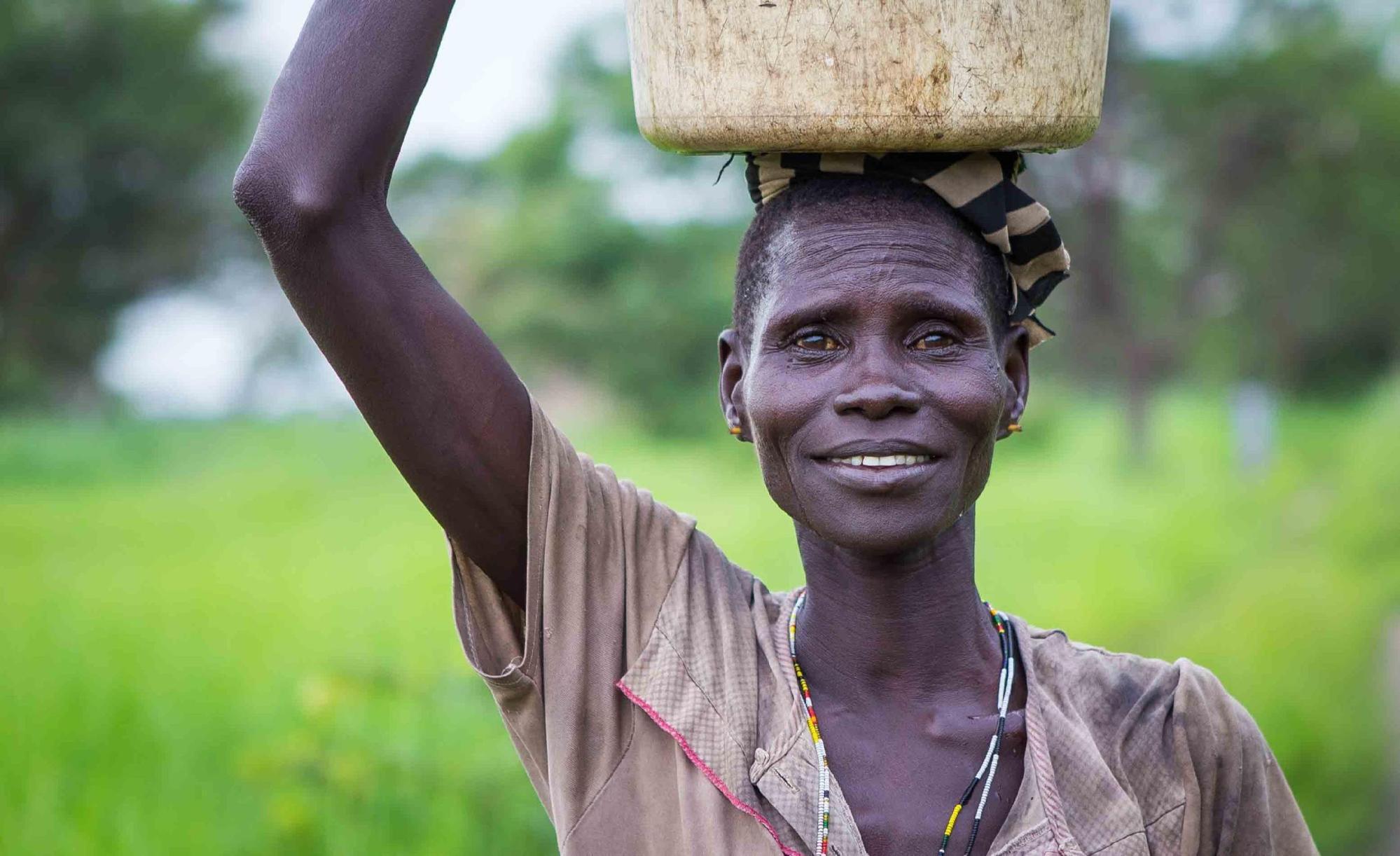 A Dinka woman fetches water in South Sudan