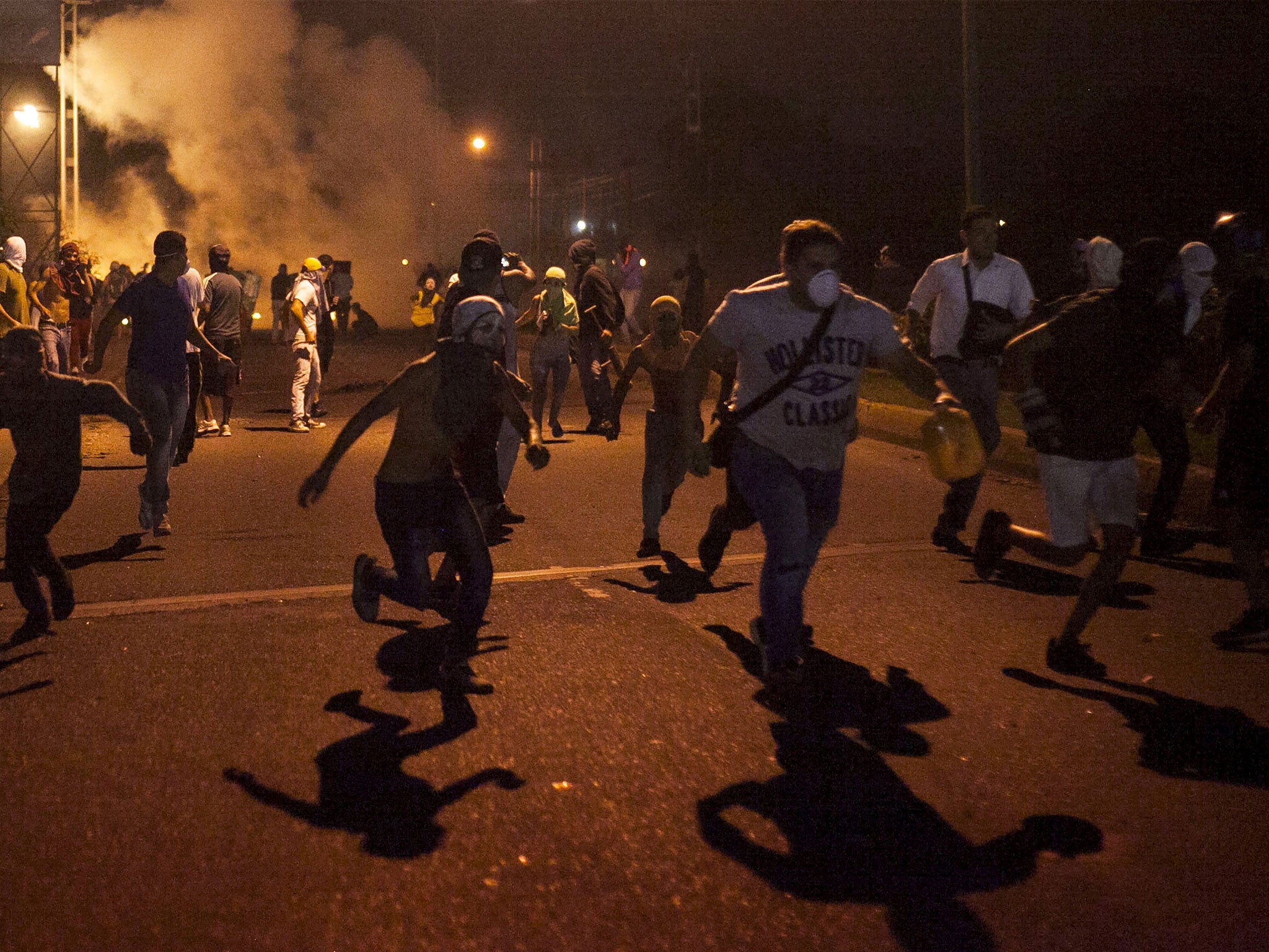A group of protesters run during clashes in Barquisimeto, Venezuela on 5 May