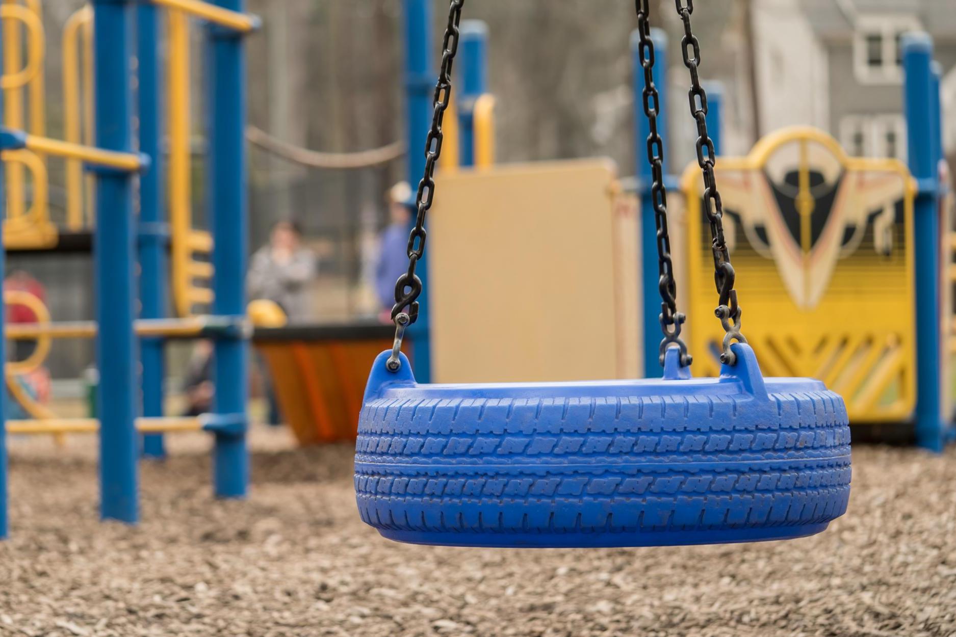 Picture: Blue tire swing in a empty playground/