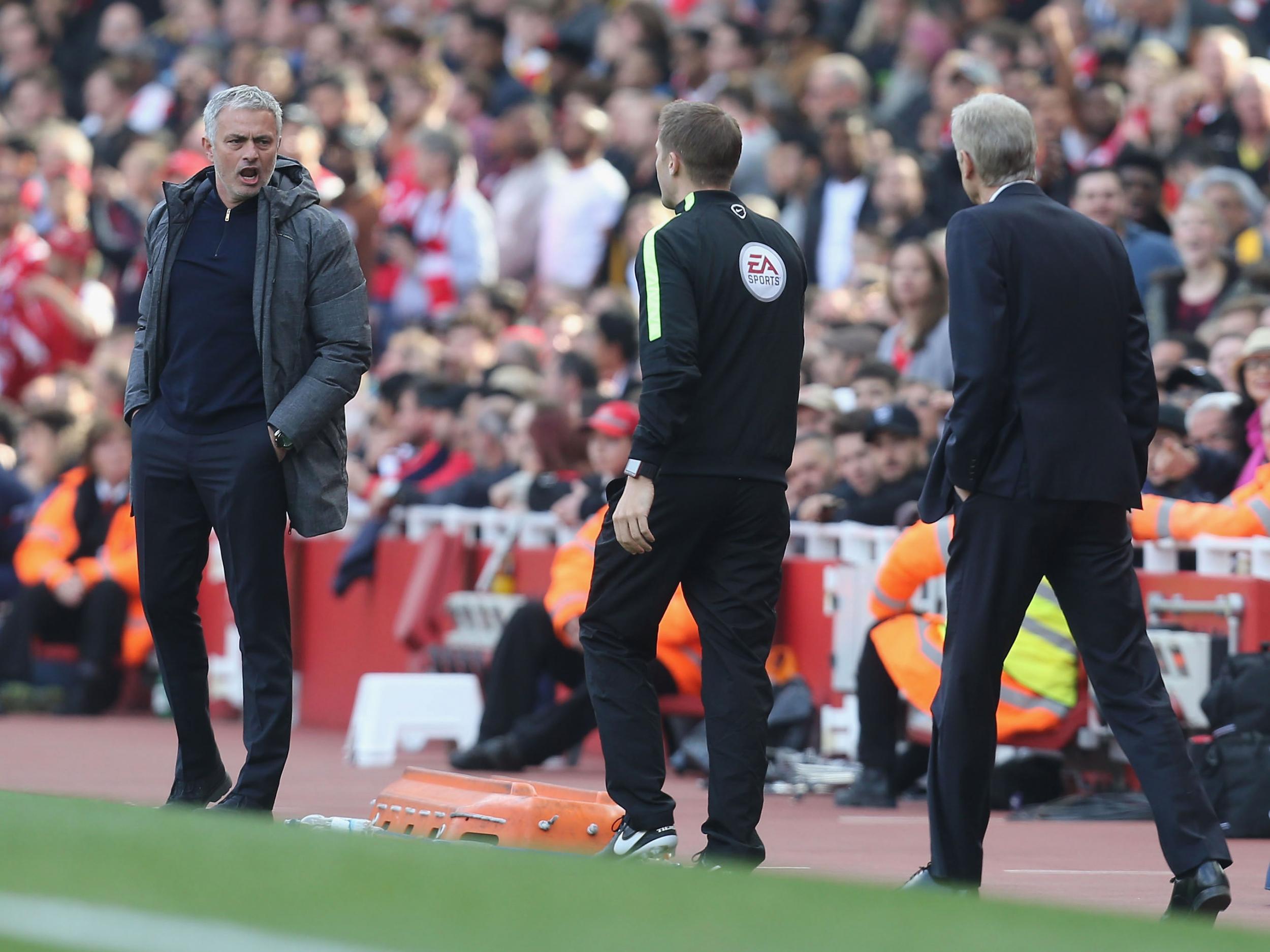 Mourinho was not happy with Wenger talking to the fourth official (Getty )