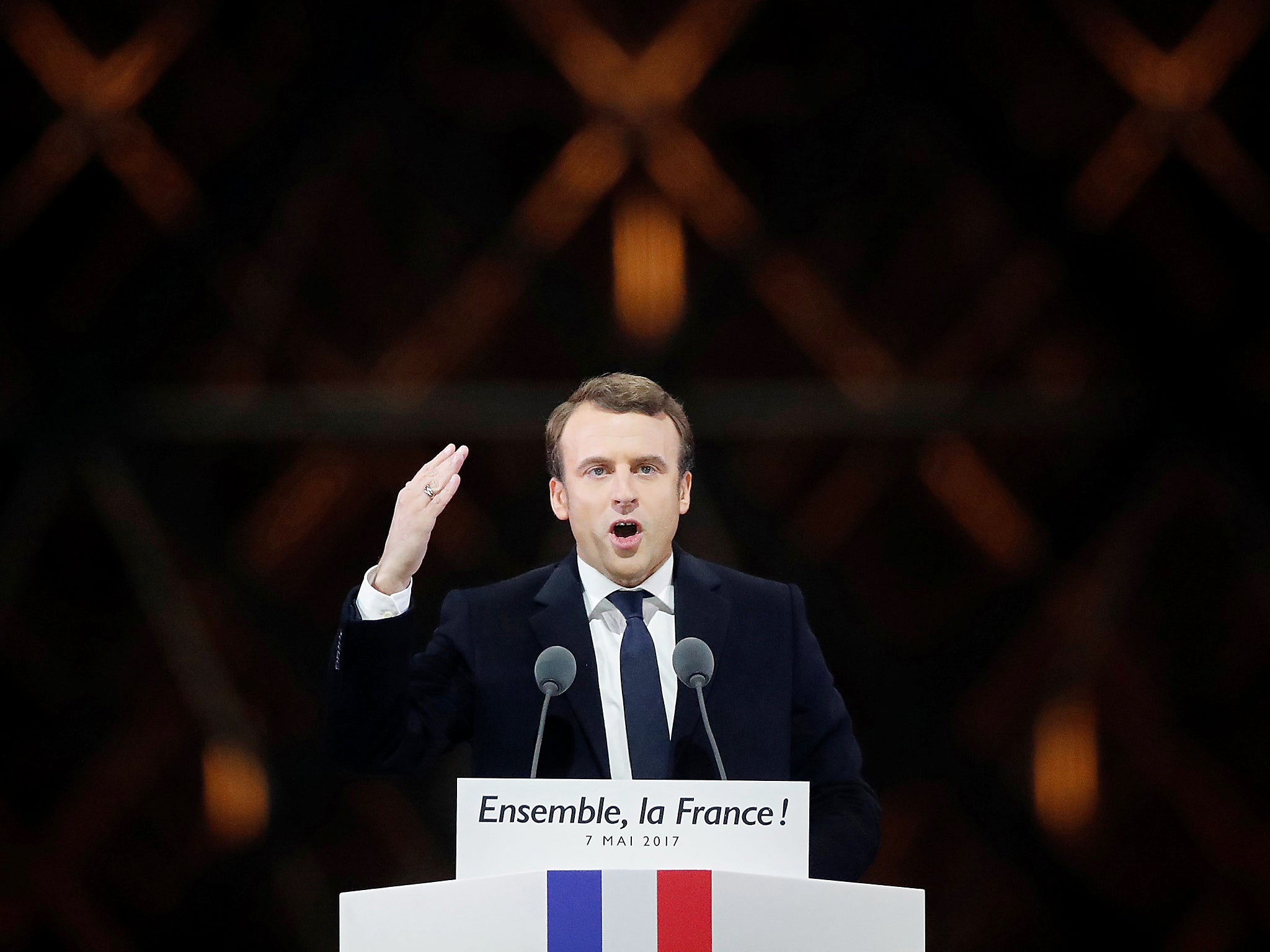 French President-elect Emmanuel Macron celebrates on the stage at his victory rally near the Louvre in Paris