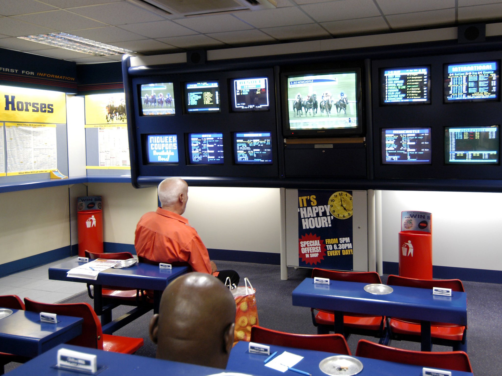 A William Hill betting shop: the bookie is one of five which have agreed to pump money into treating gambling addiction