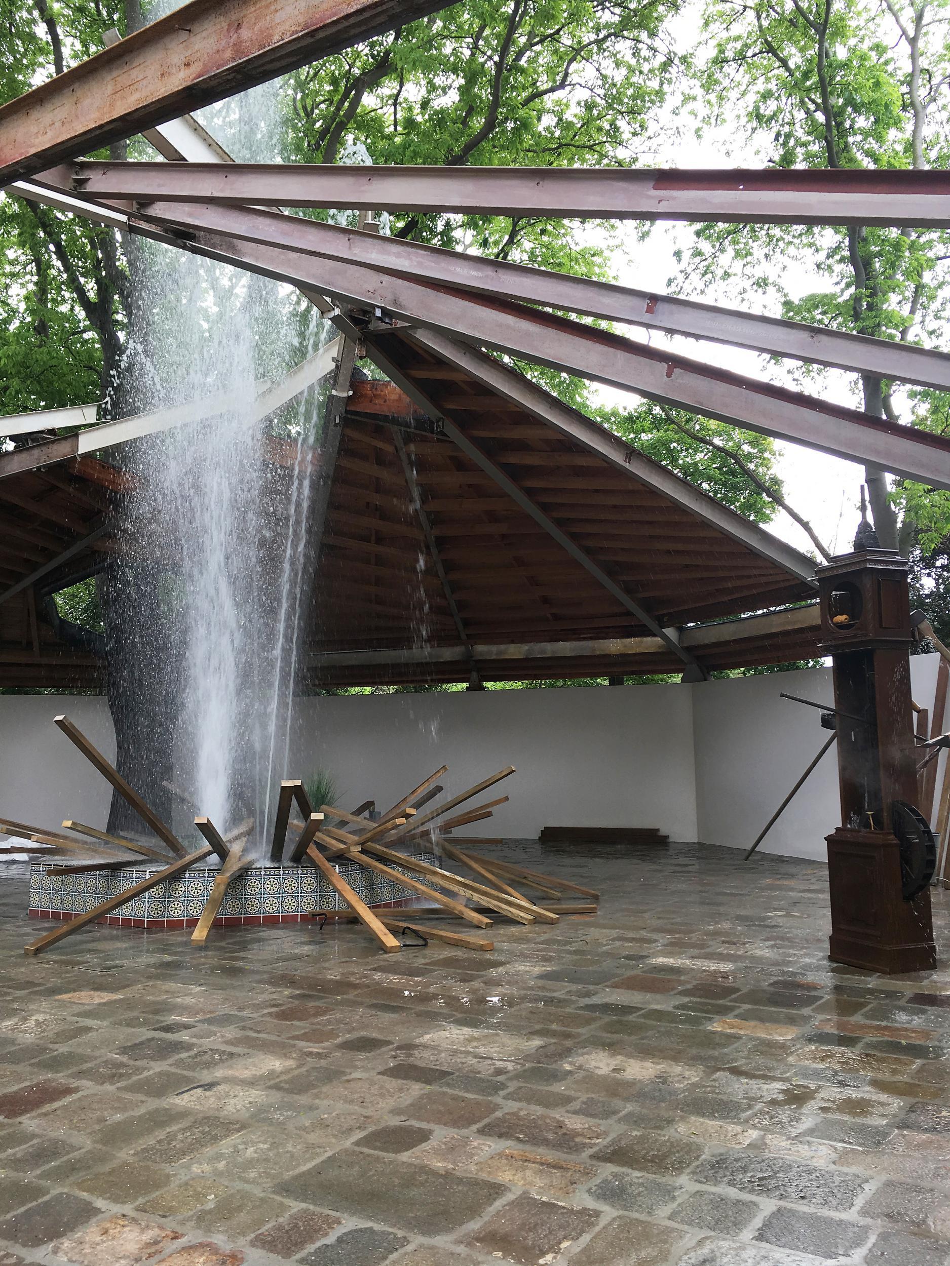 &#13;
Over at the Canadian Pavillion, Geoffrey Farmer's jet of water from a Moorish fountain has blasted three quarters of the roof away, exposing the girders&#13;