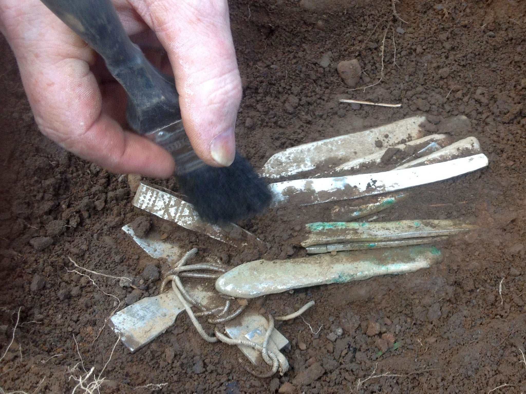 An archaeologist preparing the top level for removal of the hoard of Viking treasure found by Derek McLennan