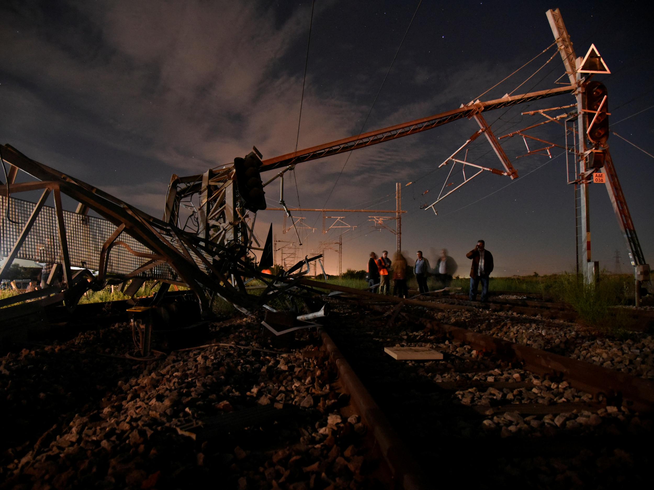 Firefighters work near debris in Adendro