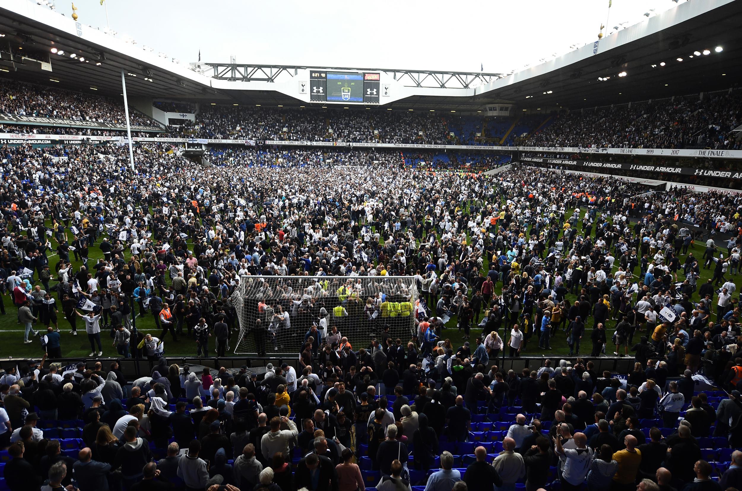 Tottenham's fans spill out on to the pitch after the final whistle at White Hart Lane